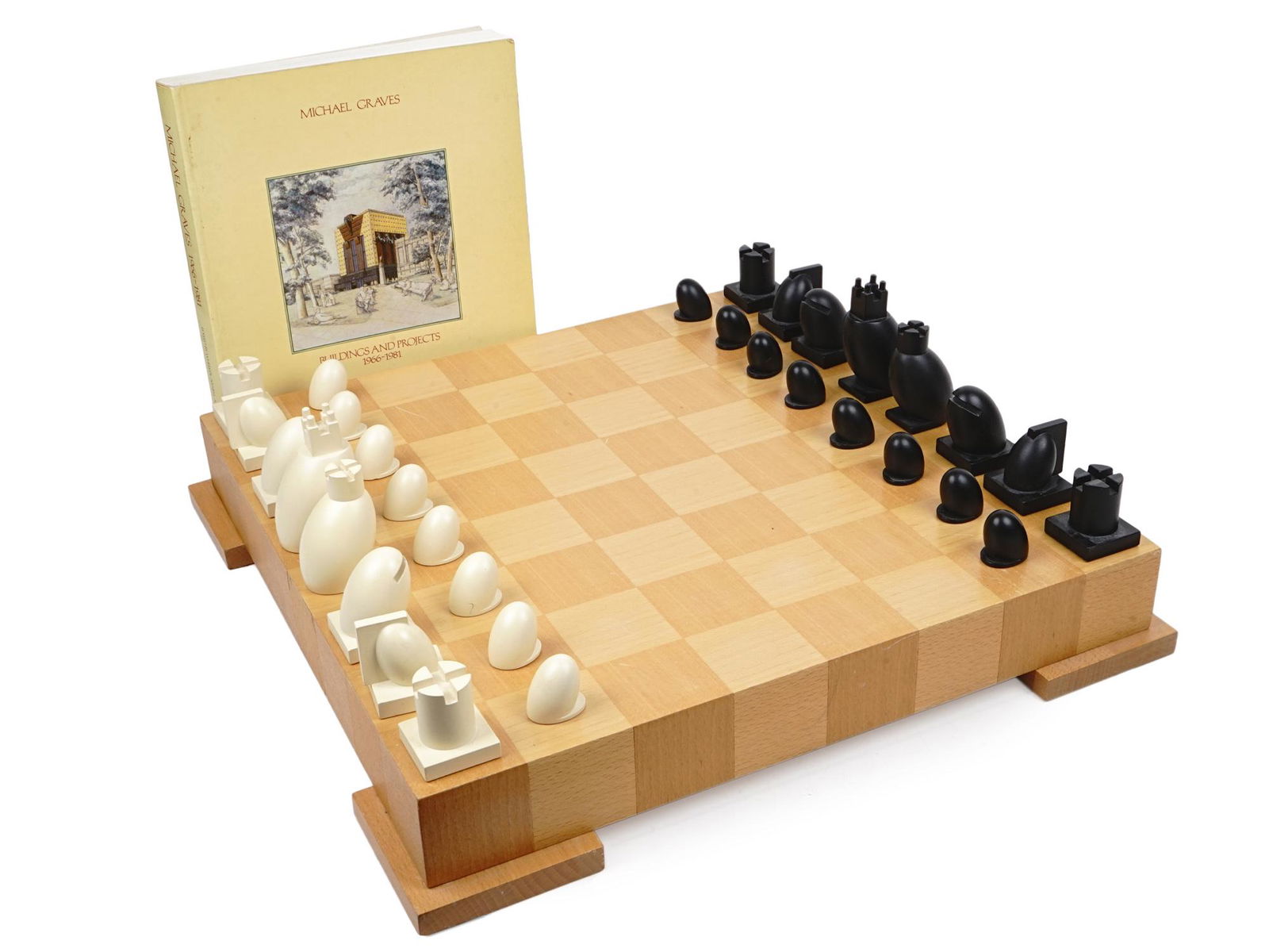 POSTMODERN CHESS SET BY ARCHITECT MICHAEL GRAVES: Vintage 1990s and original Chess and Checkers Set in a Postmodern design by famous American architect Michael Graves. Board made of wood which is done with a mosaic inlaid of two variants of maple. Th