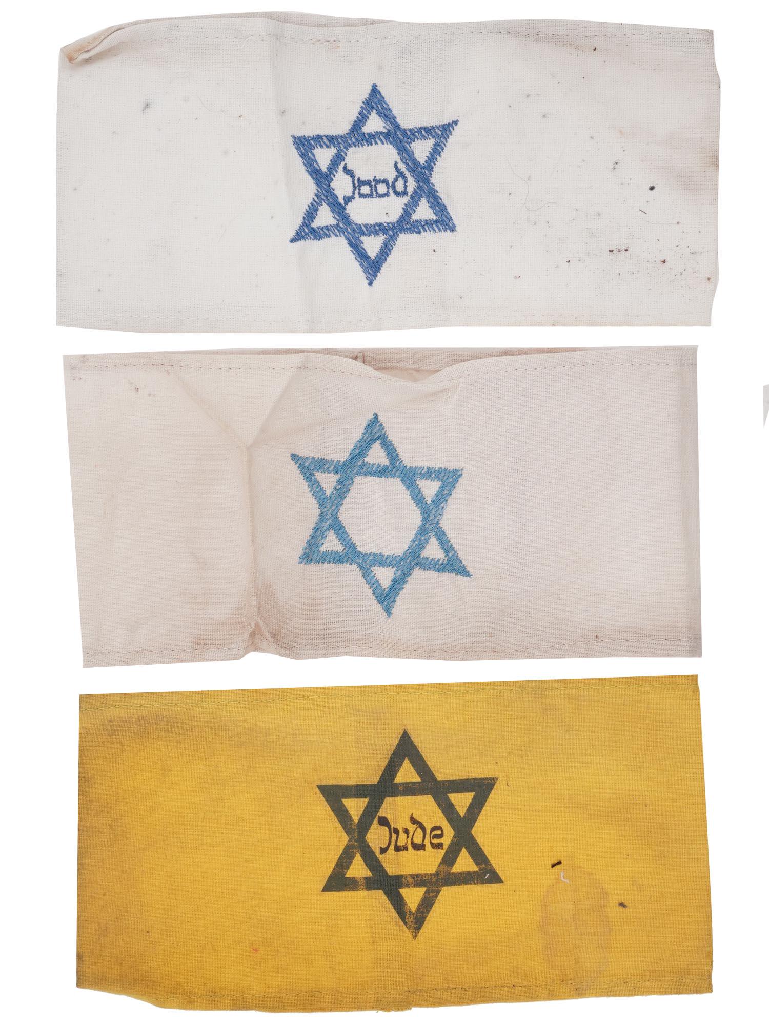 WWII HOLOCAUST JEWISH GHETTO ARMBANDS, 3 PCS: A lot of three World War II Jewish ghetto armbands. A pair of armbands with Magen David and inscription Jude, Jew, one is hand-emboridered. The third has a hand-emboridered Magen David. During the Wor