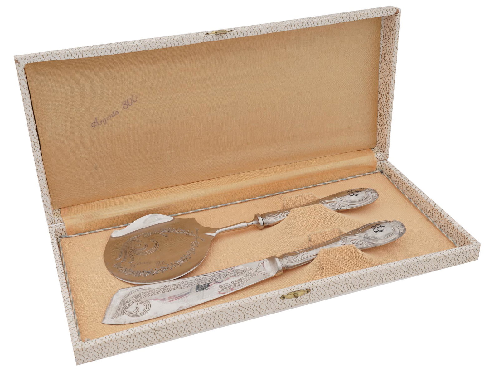 NAZI GERMAN SILVER EVA BRAUN SERVING TOOL SET: A Nazi German silver tableware set consisting of two serving tools with lower parts featuring foliate engravings. The handles are decorated with cast floral designs and marked EB for Eva Braun. Marked