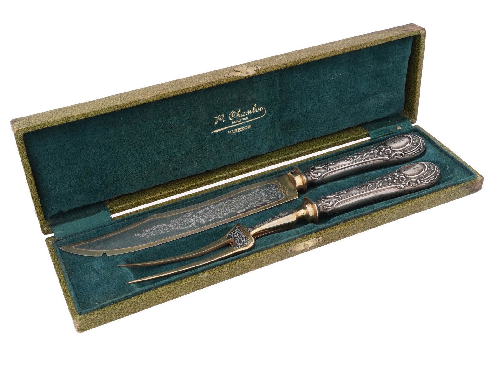 WWII NAZI ADOLF HITLER SILVER CARVING FORK KNIFE: A WWII Nazi German silver tableware carving set consisting of a fork and knife with gilt lower parts featuring scrolling foliate etchings used to belong to Adolf Hitler. The handles are decorated with