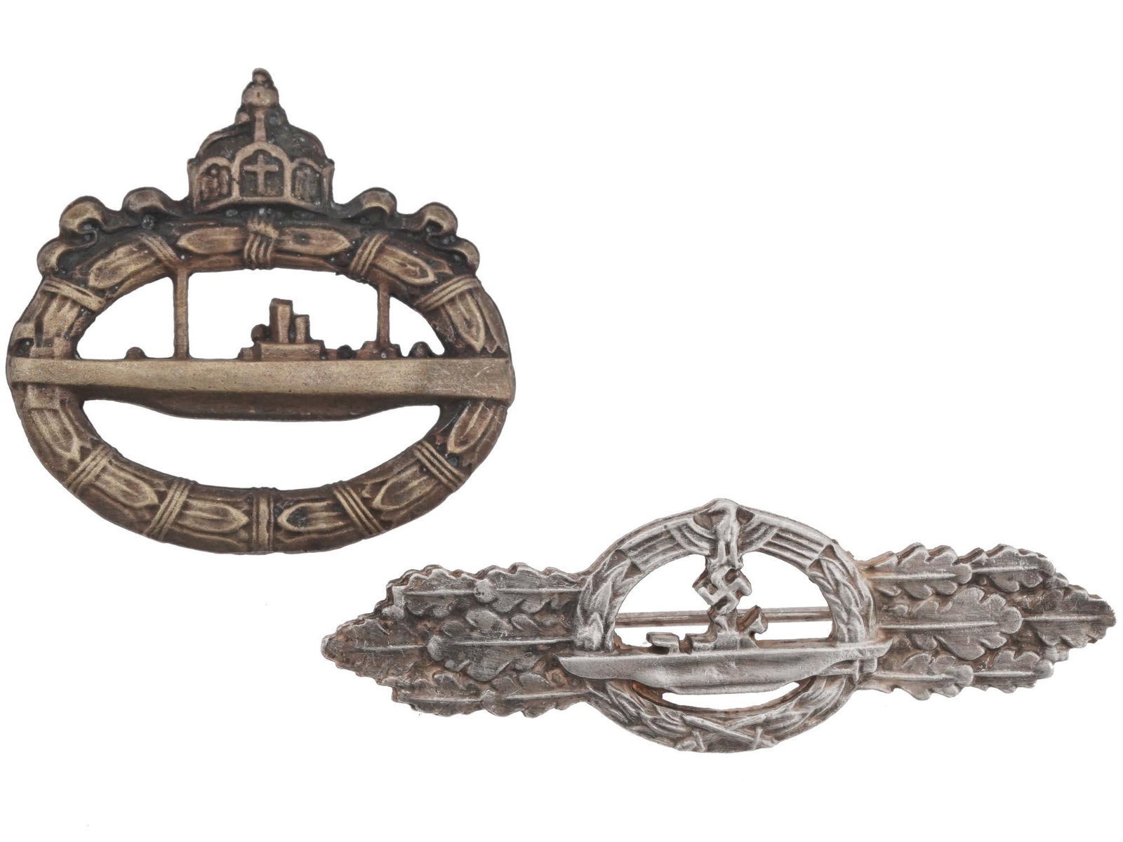 PRUSSIAN AND NAZI GERMAN U BOAT BADGES, 2 PCS: A pair of German military decorations, World War I Imperial U-Boat badge and World War II U-Boat front clasp. Both pieces are marked on the backside, Sekhaus, Ausf. Schwer Berlin. First And Second Wor