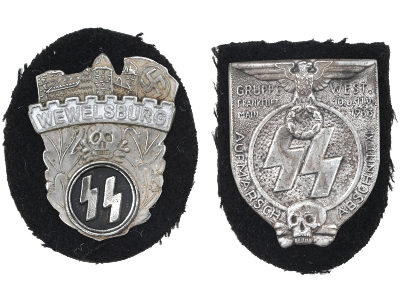 WWII NAZI GERMAN THIRD REICH SS SHIELDS, 2 PCS: A group of two WWII Nazi German SS shields including a Wewelsburg SS Academy sleeve badge shield with engraved images of a castle and a swastika on top, the inscription Wewelsburg, oak leaves, a skull