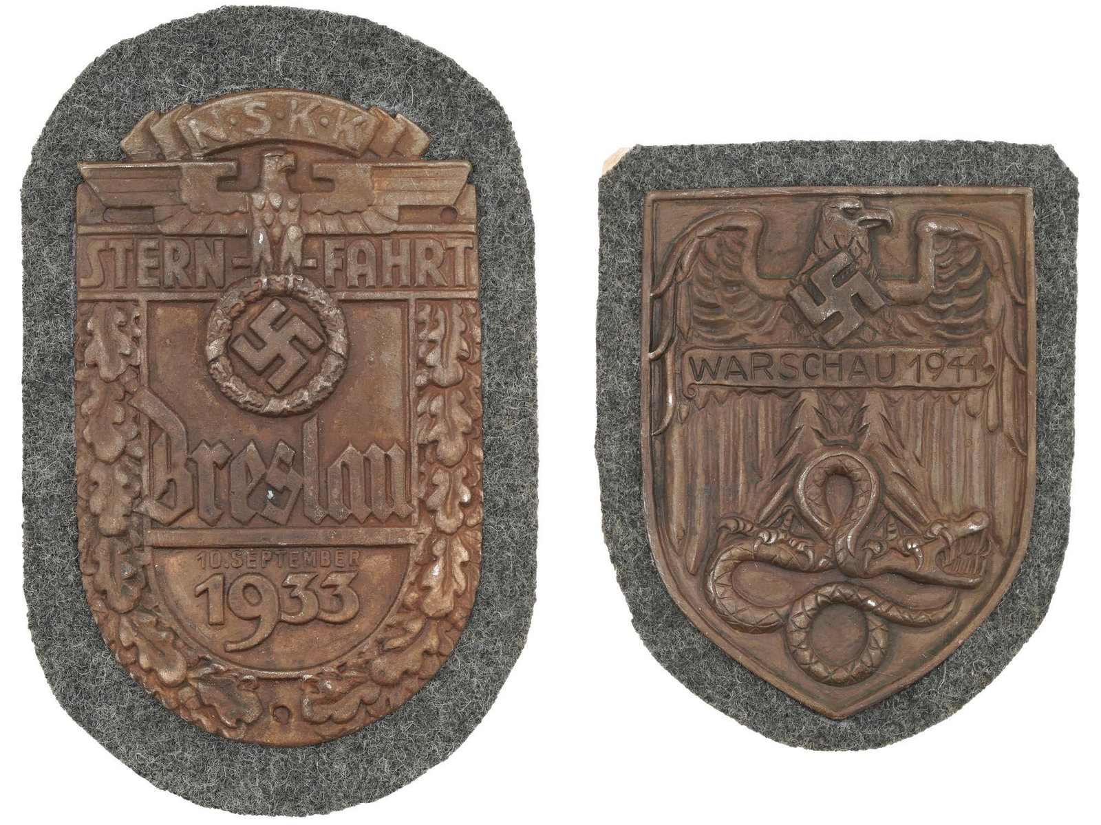 WWII NAZI GERMAN WARSAW AND NSKK BRESLAU SHIELDS: A pair of World War II German decorations, the Warsaw Shield and the NSKK Breslau Shield. The Warsaw Shield feature an eagle standing on a snake and inscription Warsaw 1944. The Breslau Shield depicts