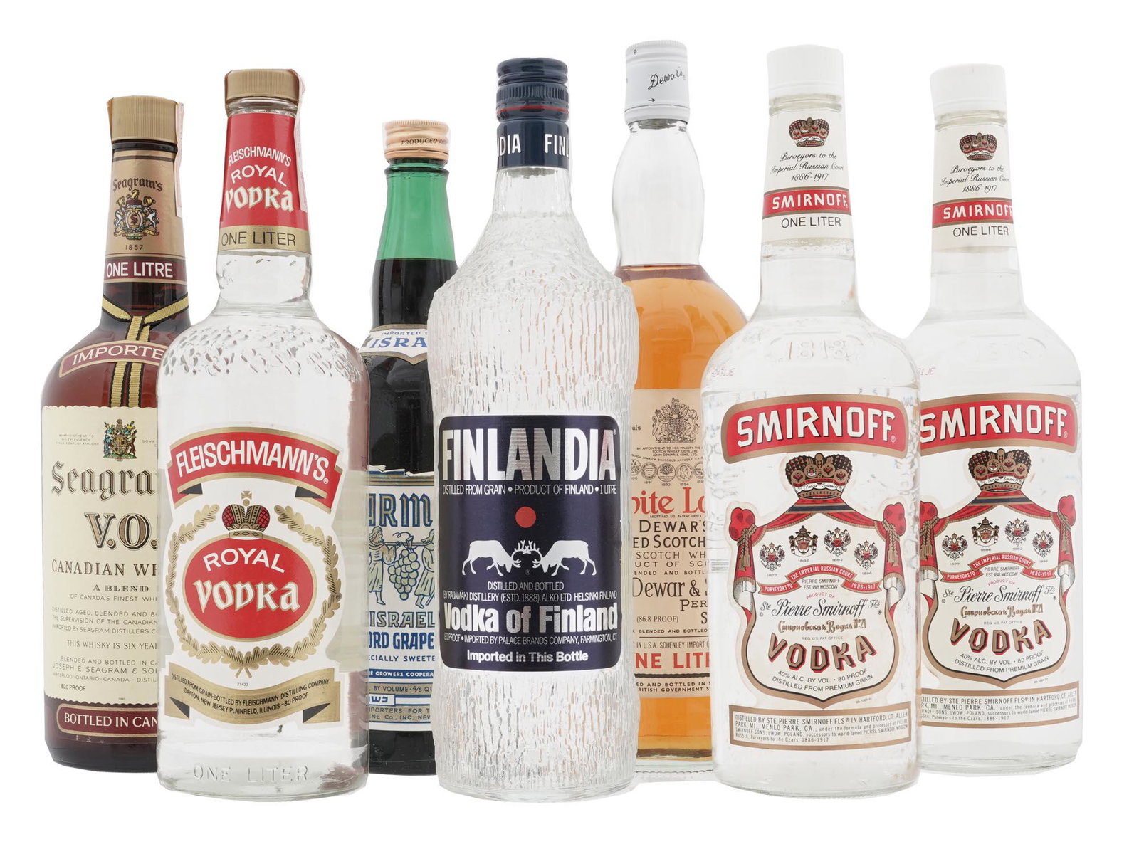COLLECTION OF ALCOHOL DRINKS IN VINTAGE BOTTLES: A large lot of alcohol drinks in vintage bottles including Smirnoff and Finland vodka, Carmel grape wine, White Label Dewards blended Scotch whisky, Seagrams Canadian whisky, and more. For collecting 