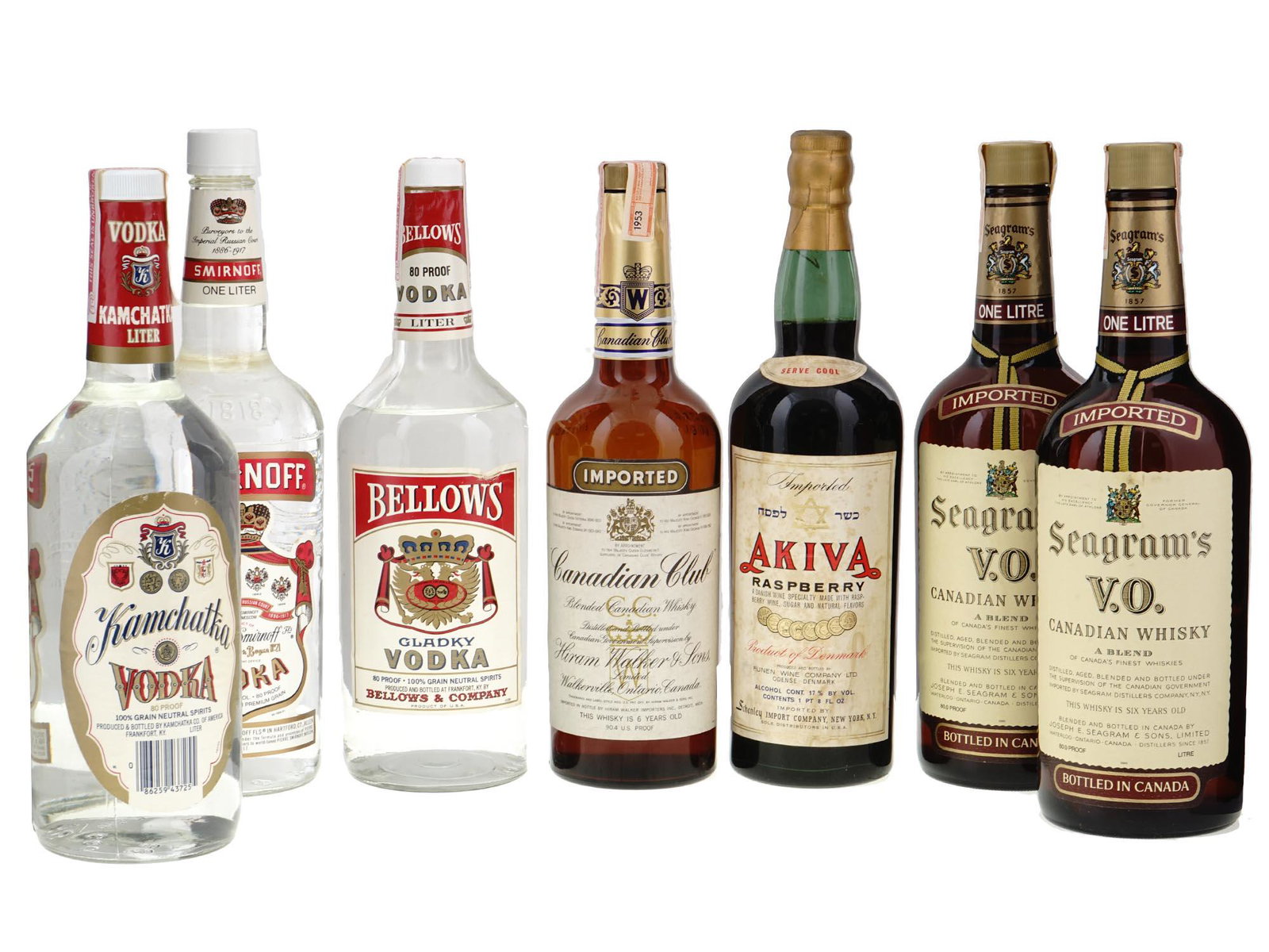 COLLECTION OF ALCOHOL DRINKS IN VINTAGE BOTTLES: A large lot of alcohol drinks in vintage bottles including Smirnoff, Bellows and Kamchatka vodka, Canadian Club whisky, Akiva raspberry wine, Seagrams Canadian whisky, and more. For collecting purpose