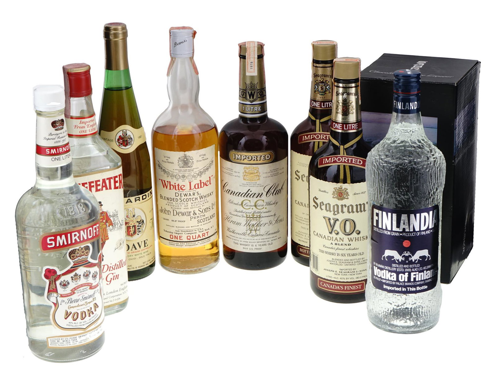 COLLECTION OF ALCOHOL DRINKS IN VINTAGE BOTTLES: A large lot of alcohol drinks in vintage bottles including Smirnoff and Finlandia vodka, Fleischmanns vodka, Carmel grape wine, Seagrams Canadian whisky, White label Dewards blended Scotch Whisky, and