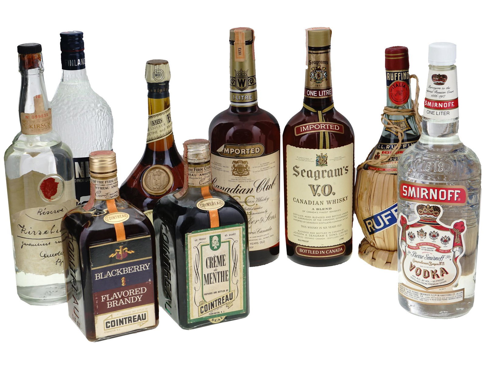 COLLECTION OF ALCOHOL DRINKS IN VINTAGE BOTTLES: A large lot of alcohol drinks in vintage bottles including Dom B and B liquor, Ruffino wine, Canadian Club whisky, Seagrams Canadian whisky, Cointreau blackberry flavored brandy, Cointreau creme de me