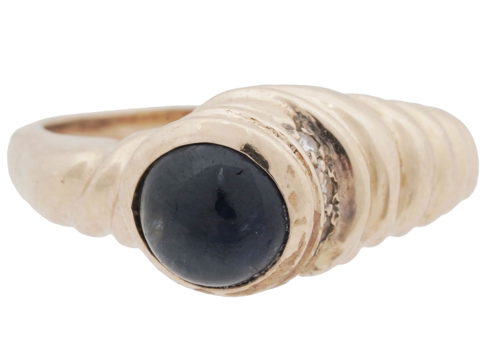 18K YELLOW GOLD AND SAPPHIRE STATEMENT RING: A vintage 14K yellow gold statement ring. Twisted front design with a central sapphire cabochon and three crystals on the side. Total Weight: 5 grams. Elegant Luxury Jewelry For Women. Dimensions: Ove