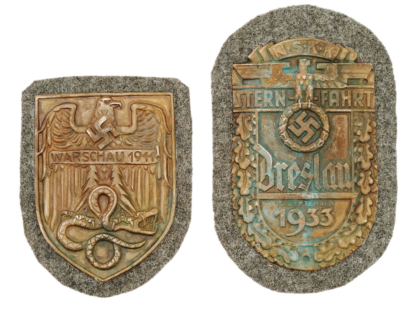 WWII NAZI GERMAN WARSAW AND NSKK BRESLAU SHIELDS: A pair of WWII Nazi German decorations, the Warsaw Shield and the NSKK Breslau Shield. The Warsaw Shield features an eagle standing on a snake and inscription Warsaw 1944. The Breslau Shield depicts a
