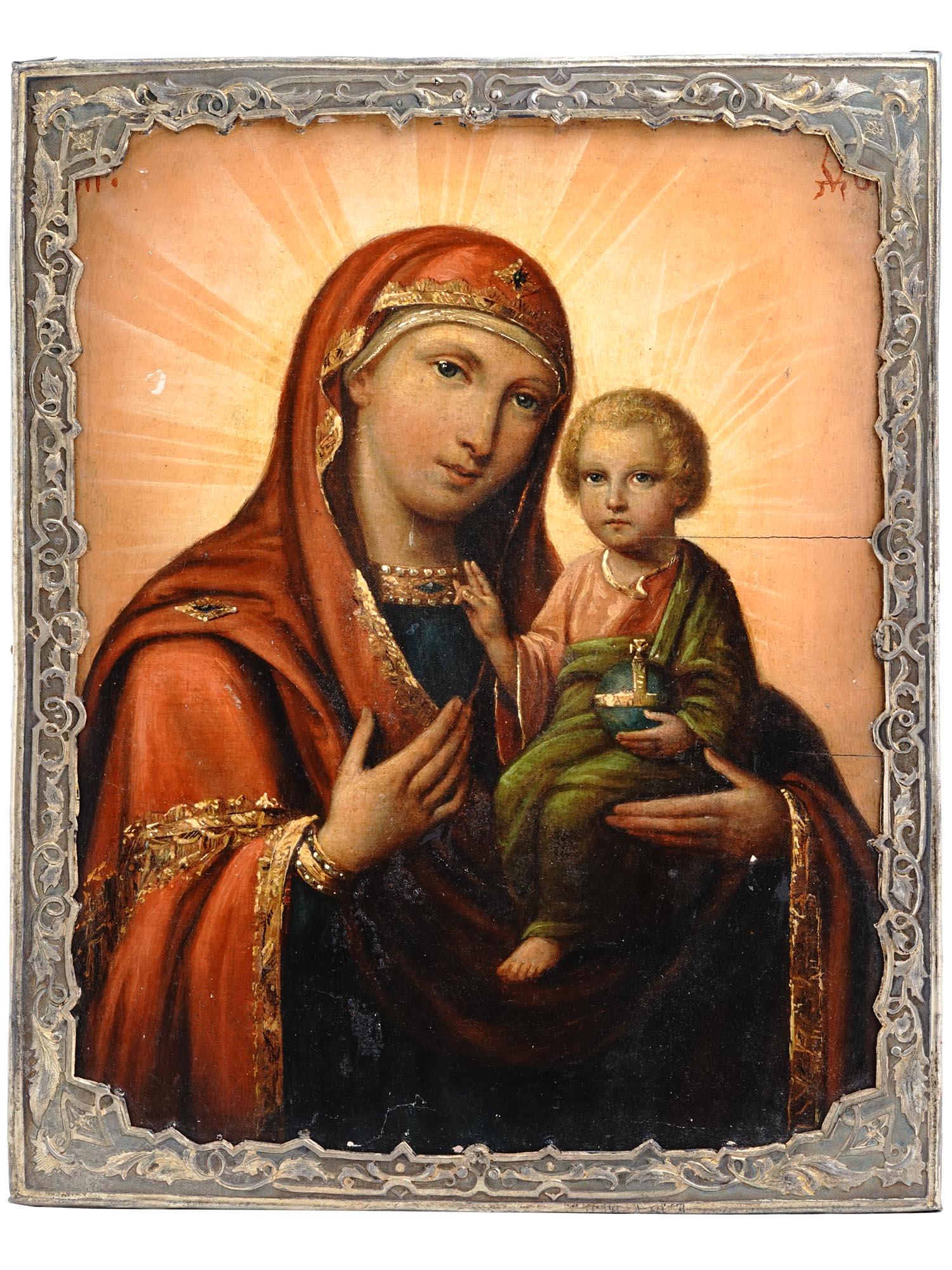 ANTIQUE RUSSIAN ICON MOTHER OF GOD IN SILVER RIZA: An antique 19th-century Russian Orthodox icon of Mother of God with Baby Jesus, Hodegetria iconography. Mixed media painting: egg tempera, gesso, and levkas on a wood board. Gilt silver riza or oklad