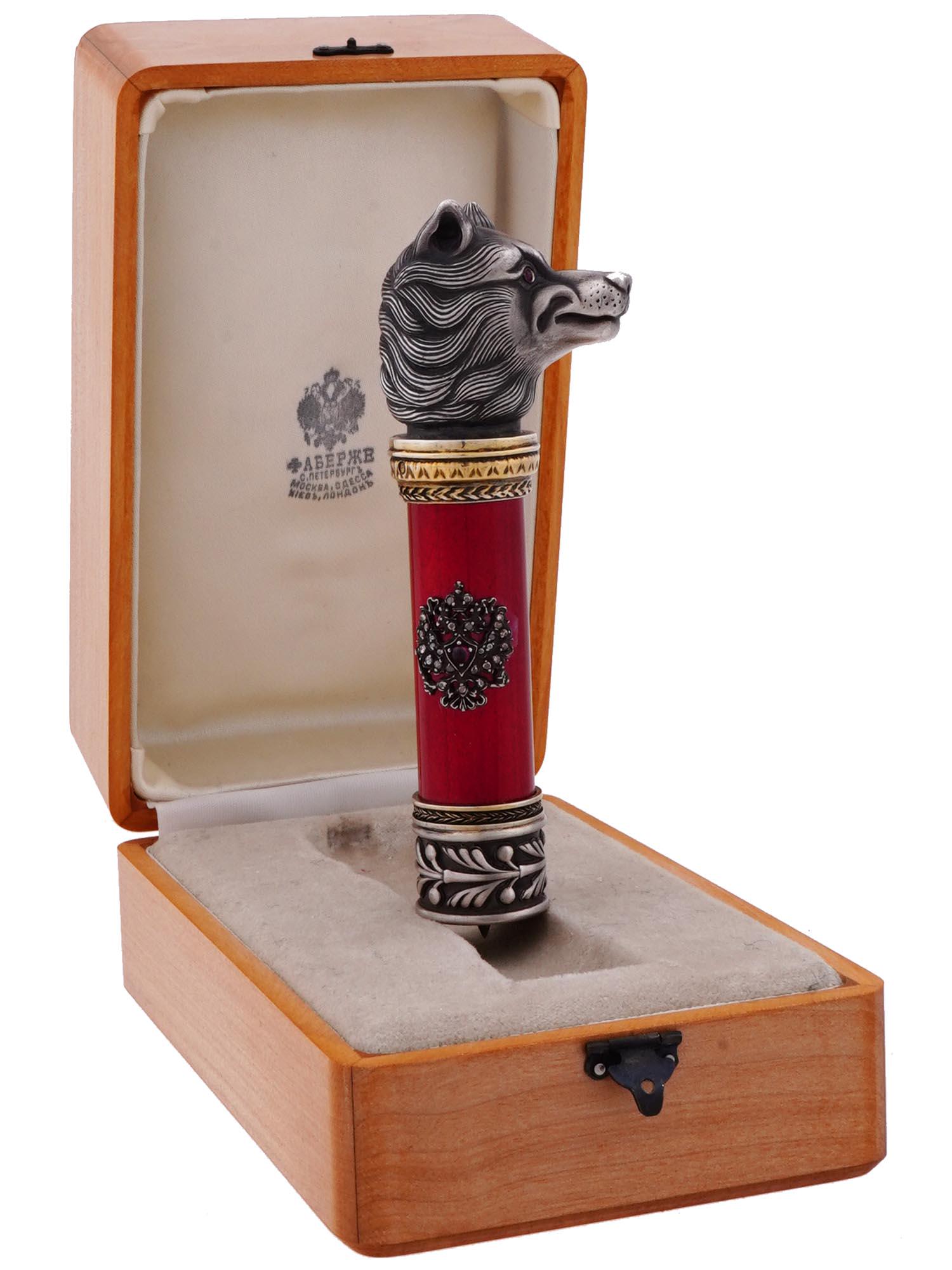 RUSSIAN SILVER ENAMEL STONE DOG HEAD CANE HANDLE: A Russian silver cane handle decorated with the Russian Imperial double headed eagle set with diamonds and gemstones on the red enameled ground manufactured in the guilloche technique with outer gilt