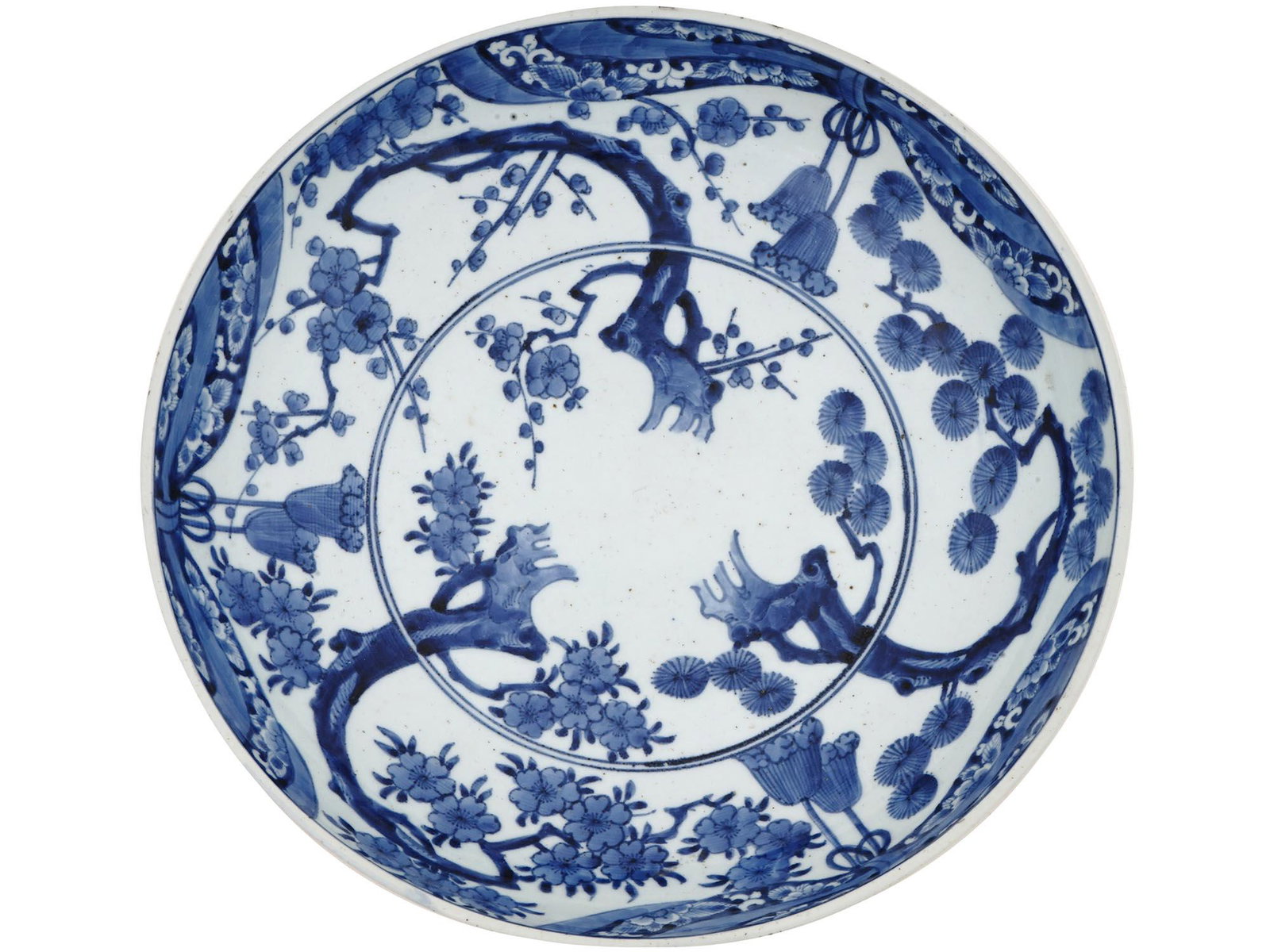 LARGE JAPANESE IMARI BLUE WHITE PORCELAIN CHARGER: A large antique Japanese Imari blue and white porcelain charger. The exterior and interior of the ware is decorated with floral and foliage motifs. Marked with six characters blue ink mark on the bott