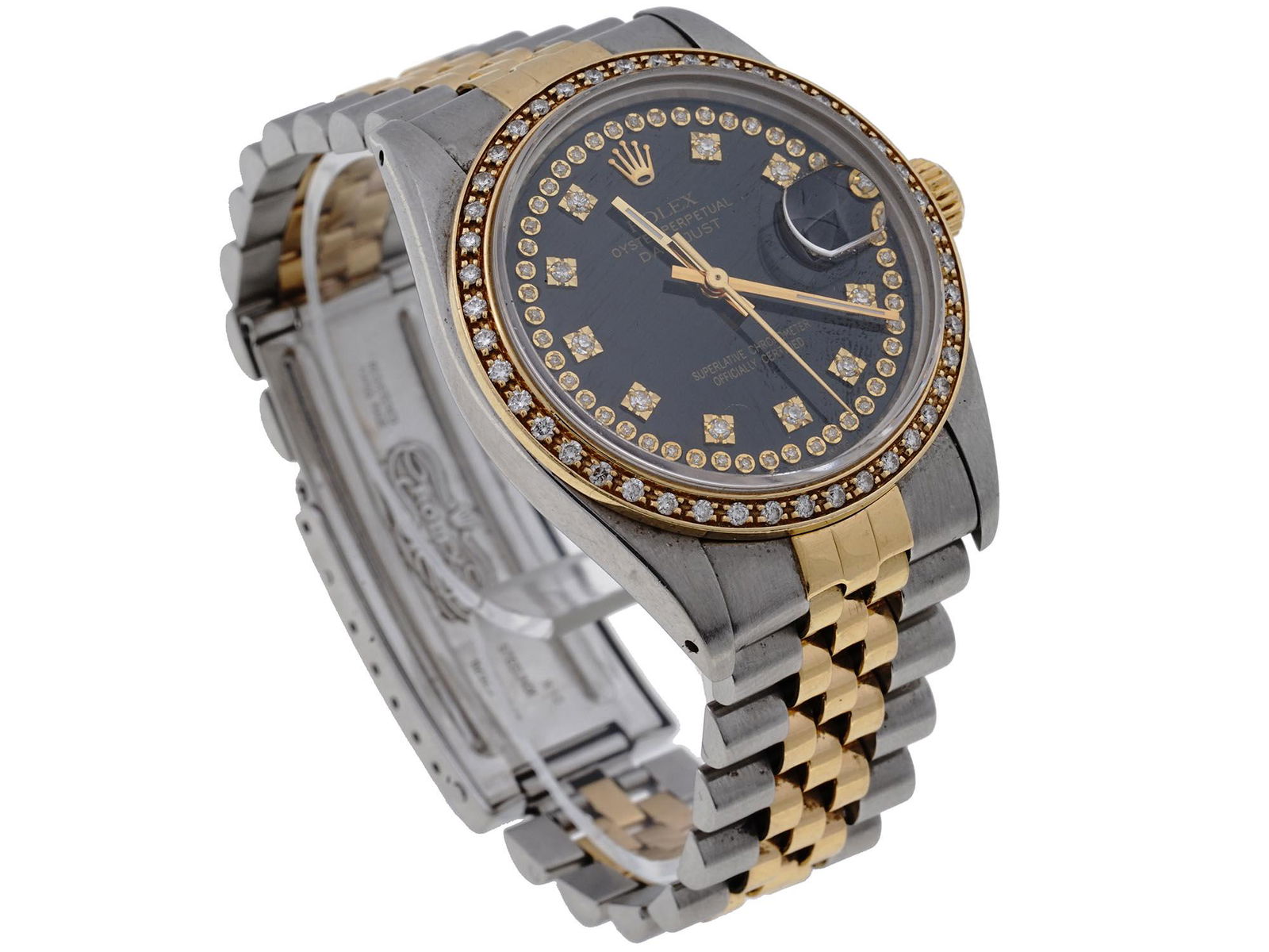 ROLEX OYSTER PERPETUAL DATEJUST DIAMOND WATCH: A vintage stainless steel automatic wristwatch with gilt accents by Rolex. Oyster Perpetual Datejust collection. The characteristic shape of the Oyster case, a bezel encrusted with diamonds, a Cyclops
