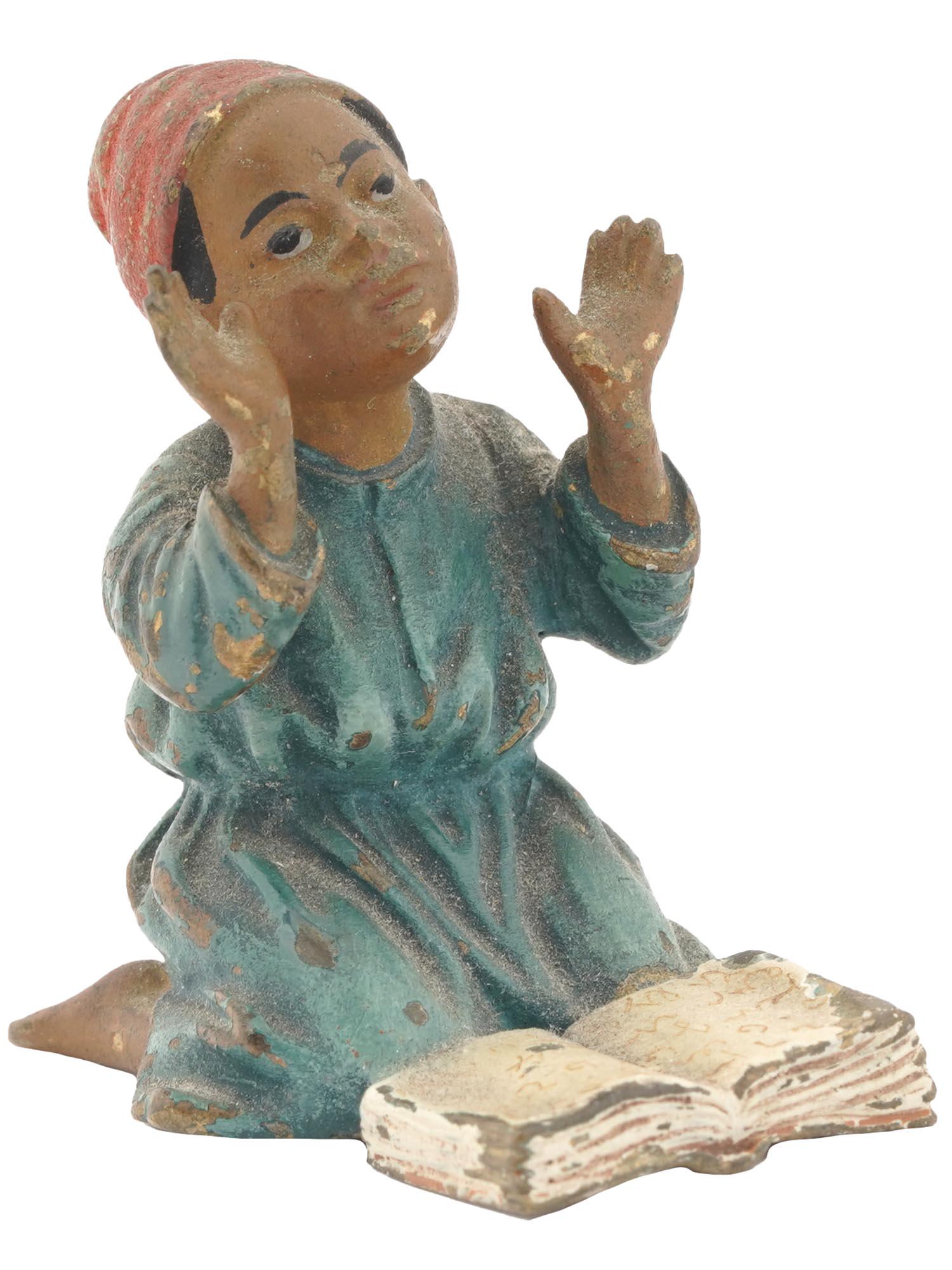 ANTIQUE VIENNA PAINTED CAST BRONZE FIGURINE OF BOY: Antique Viennese cold-painted cast bronze figurine. The figurine depicts an Arab boy praying on his knees, made in the manner of Franz Xavier Bergman, Austrian, 1861 to 1936. The figurine is adorned w