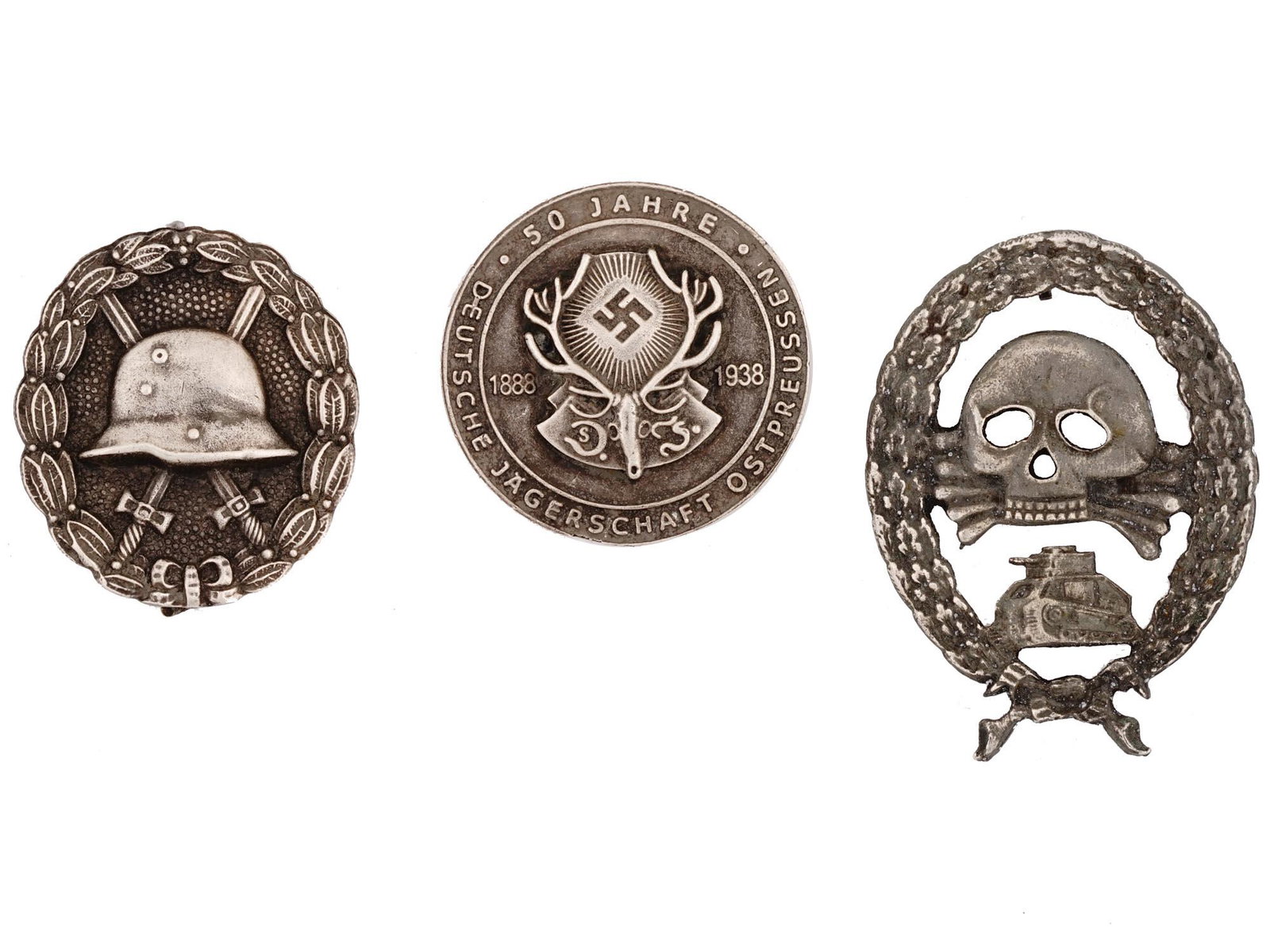 WWII NAZI GERMAN MILITARY COMMEMORATIVE BADGES: A lot of three World War II German military decorations. Condor Legion Tank badge. Deutsche Jagerschaft Ostpreussen Hunting Society 50 years anniversary commemorative badge. Wound badge. Second World 