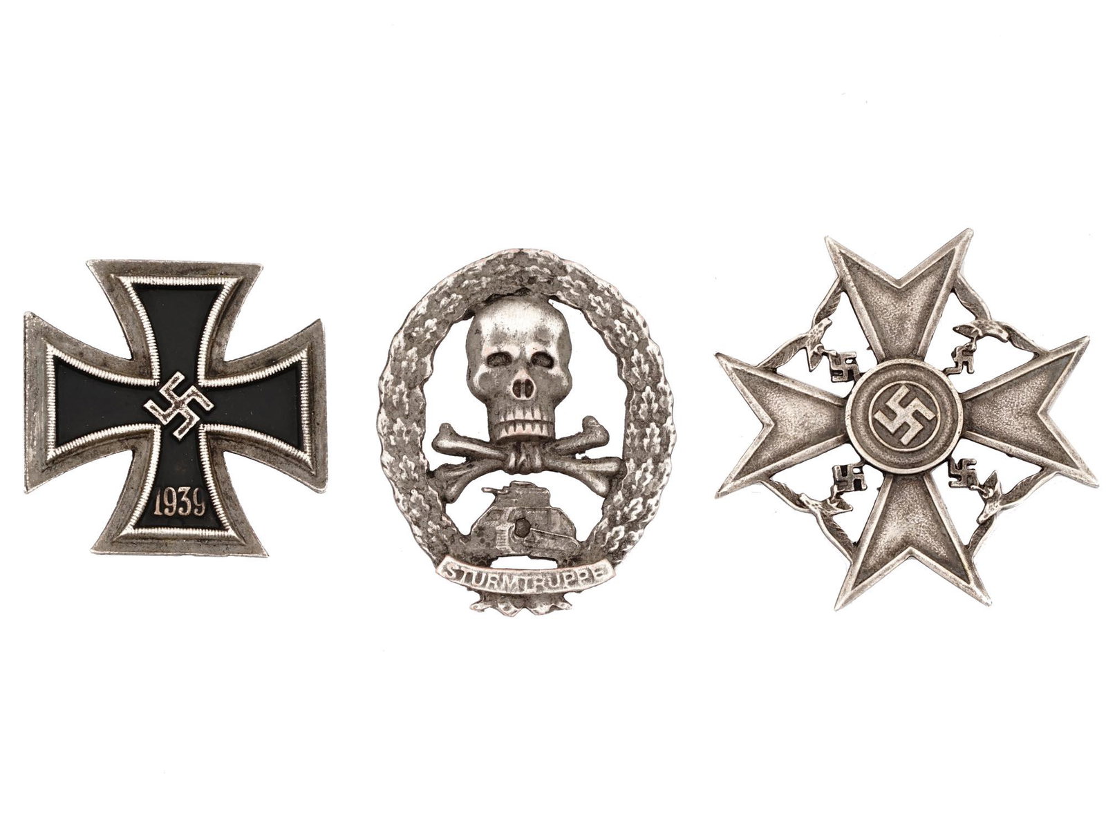 WWII NAZI GERMAN IRON AND SPANISH CROSS BADGES: A lot of three World War II German military decorations. Sturmtruppe badge. Iron Cross badge, marked RZM on the backside. Spanish Cross badge, marked RZM on the backside. Second World War Historical C