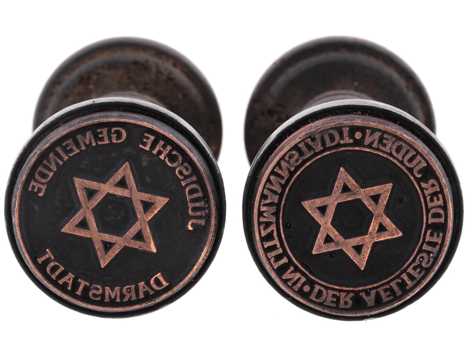 TWO HOLOCAUST PERIOD GHETTO HAND STAMPS: A pair of World War II wooden seals of ghetto administrations. Judische Gemeinde Darmstadt, Jewish Community of Darmstadt. Der Aelteste der Juden in Litzmannstadt, Council of Elders of the Jewish Ghet