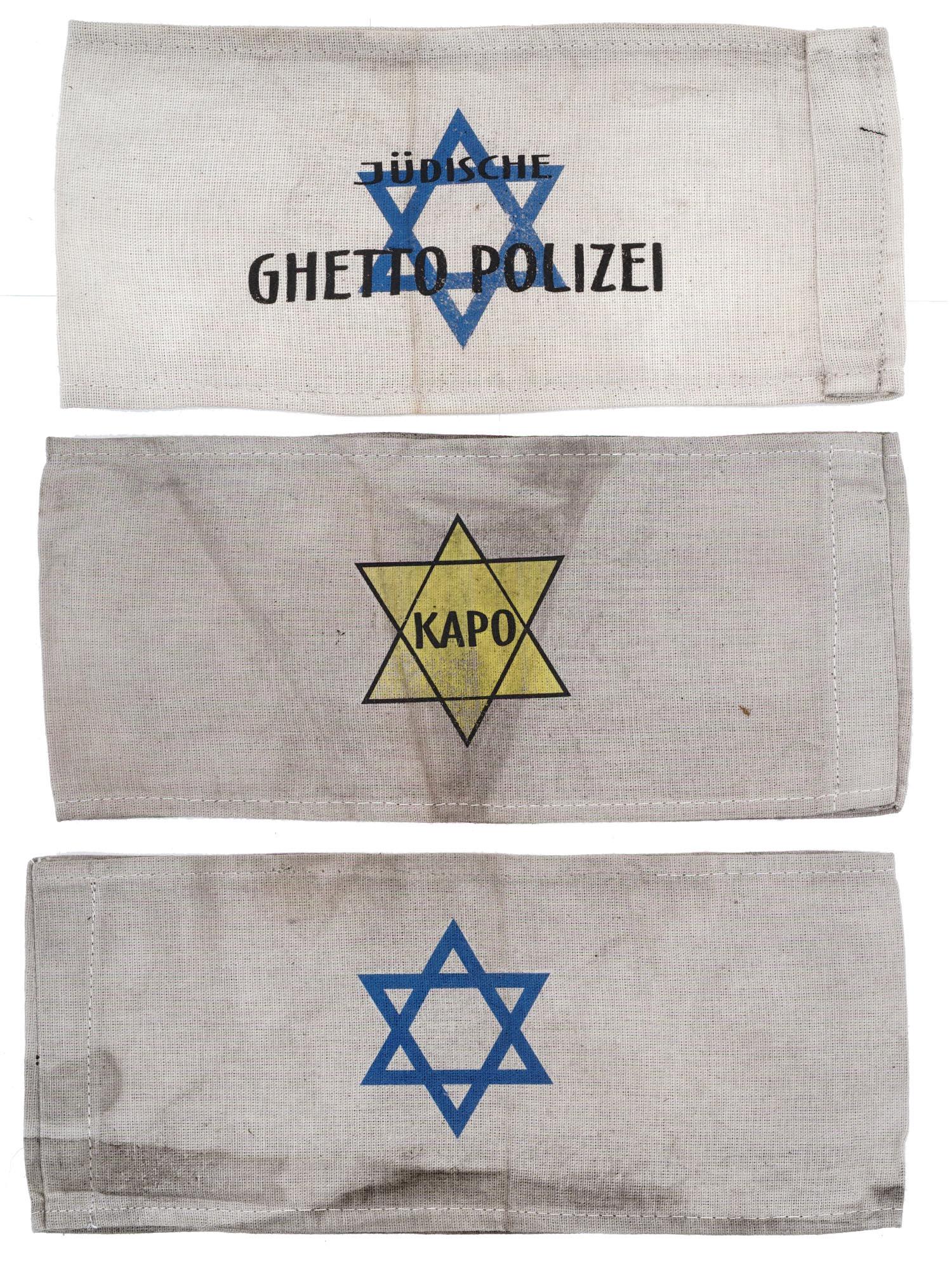 GROUP OF 3 HOLOCAUST JEWISH GHETTO ARMBANDS: A collection of three World War II Jewish Holocaust Ghetto armbands. The collection includes a Jewish Ghetto Police armband, an armband with the Star of Davis, and a Kapo armband. The word kapo design