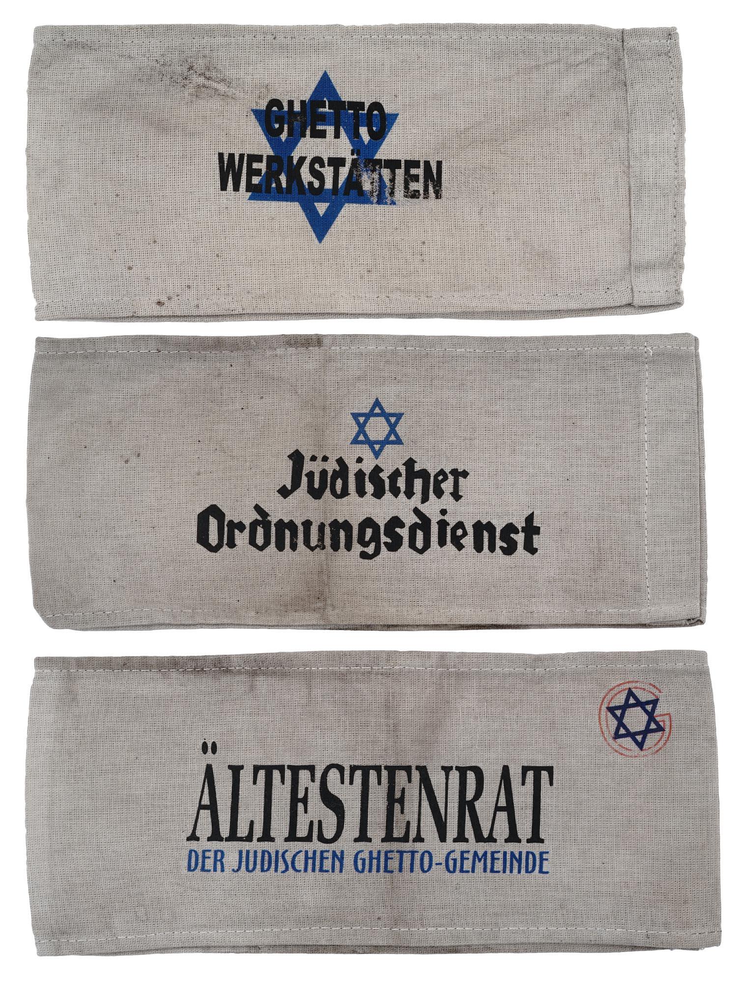 GROUP OF 3 HOLOCAUST JEWISH GHETTO ARMBANDS: A collection of three World War II Jewish Holocaust Ghetto armbands. The first is inscribed, Ghetto Werkstatten, Ghetto Workshops. The second: an armband with an inscription, Judischer Ordnungsdienst,