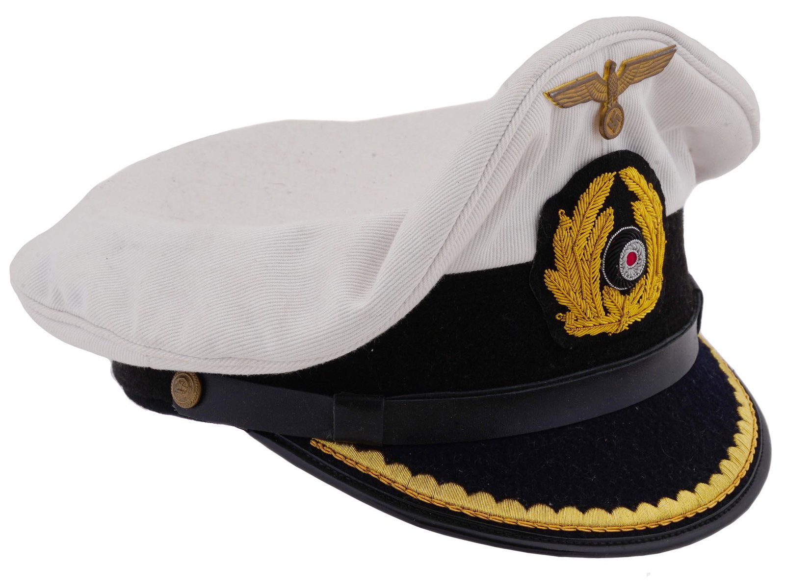 GERMAN WWII KRIEGSMARINE U BOAT CAPTAINS VISOR HAT: A WWII Nazi German Kriegsmarine U boat captains visor cap made of white cotton with hand embroidered bullion visors and wreaths, gold metal cap eagles and side buttons, patent leather chin straps, rib