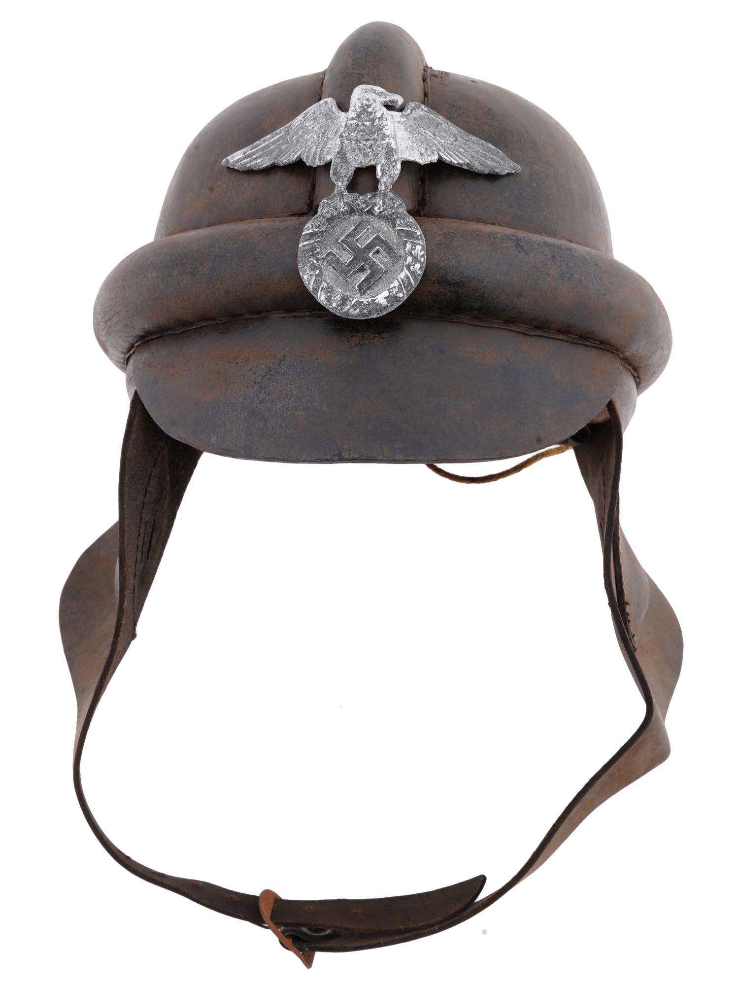 GERMAN WWII NSKK MOTORCYCLE HELMET: A WWII Nazi German NSKK motorcycle helmet. The exterior features a National Socialist Motor Corps emblem representing an eagle clutching a swastika. The interior of the helmet features a 6-fingered li