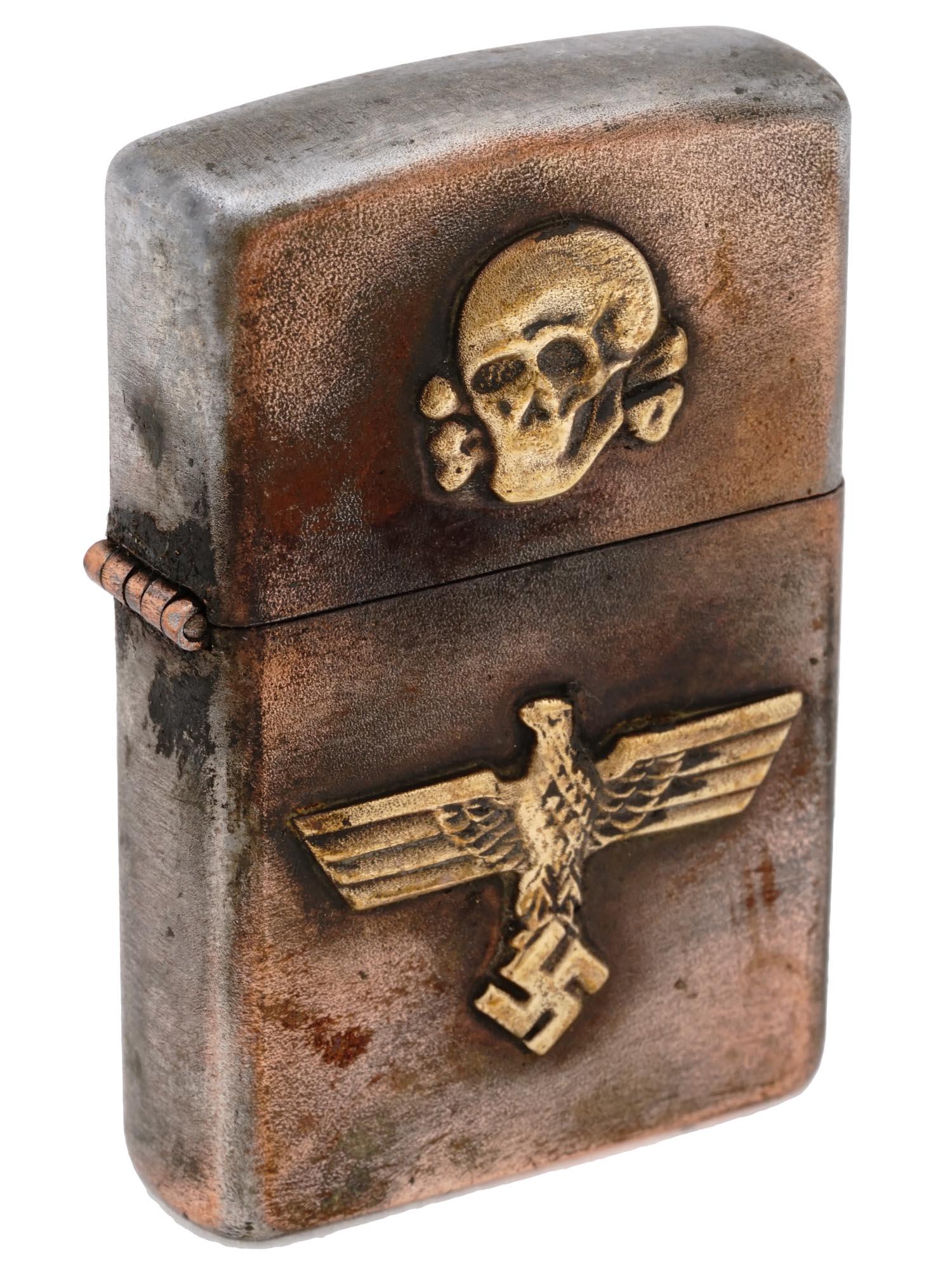 GERMAN WWII WAFFEN SS CIGARETTE LIGHTER: A World War II Nazi German military pocket gas lighter. Stainless steel body decorated with gilt overlay Reichsadler and Totenkopf. Marked RZM on the bottom. Second World War Historical Collectables A