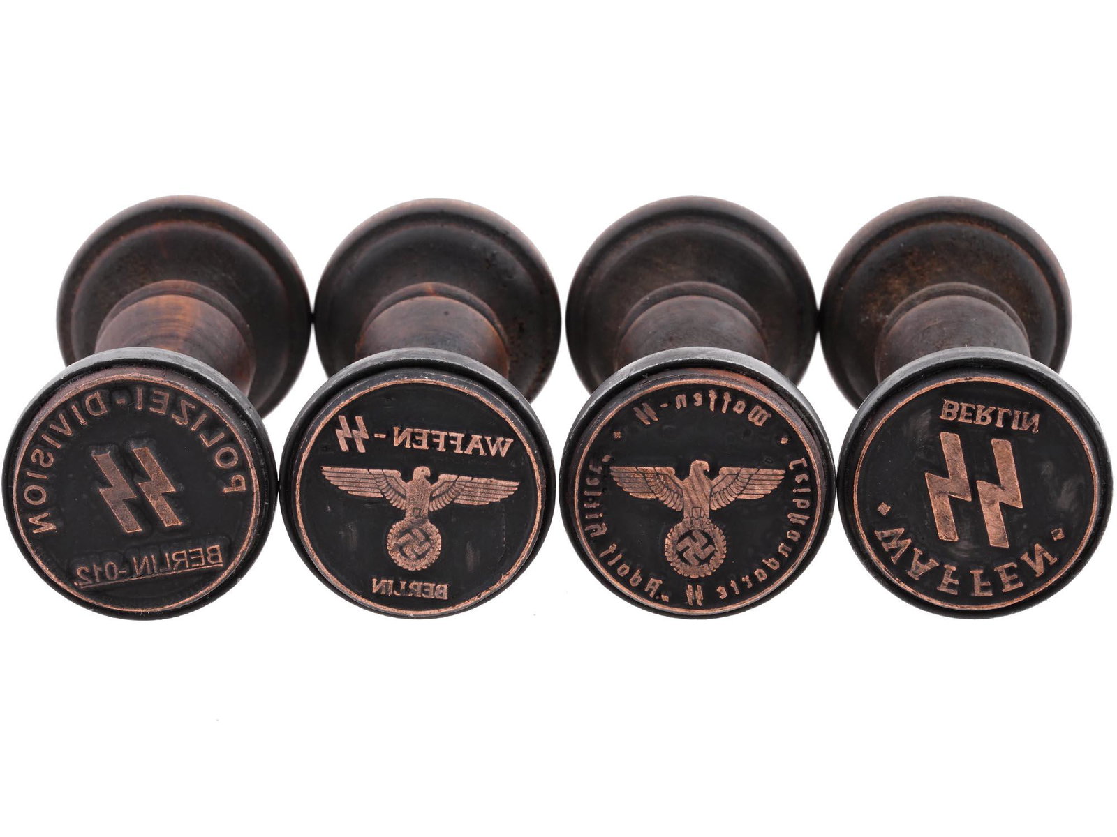 GROUP OF 4 GERMAN WWII HAND STAMPS: A lot of four World War II Nazi German wooden seals of the SS administrations. Polizei Division SS Berlin 012. Waffen SS Berlin, two pieces. Waffen SS Leibstandarte SS Adolf Hitler. The 1st SS Panzer 