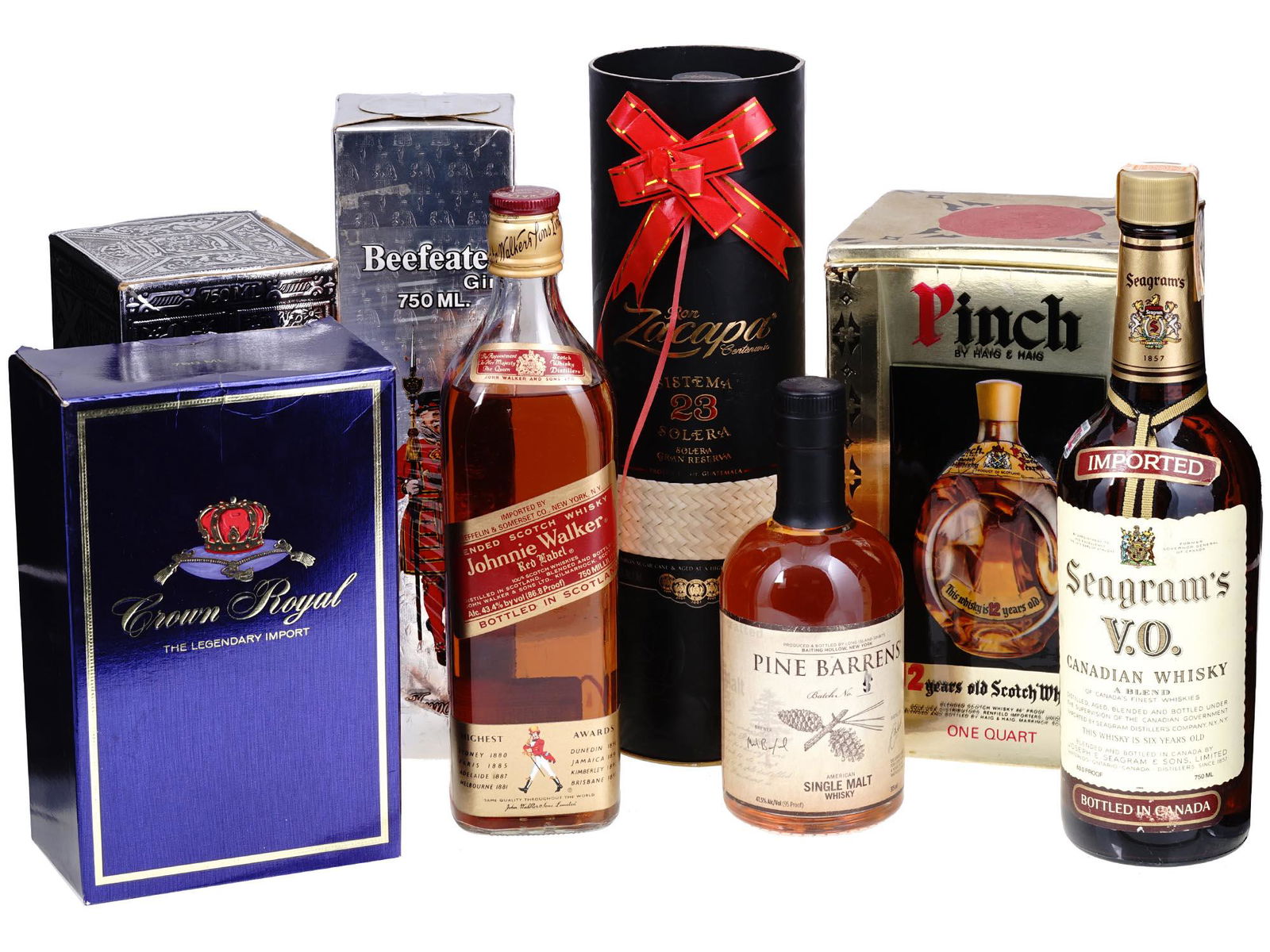 COLLECTION OF VINTAGE LIQUEUR BOTTLES: A large lot of liqueur vintage bottles including Crown Royal whisky, Chivas Regal whisky, Haig and Haig pinch scotch whiskey, Beefeater gin, John Walker Red Label whisky, Zacapa rum, Seagrams Canadian