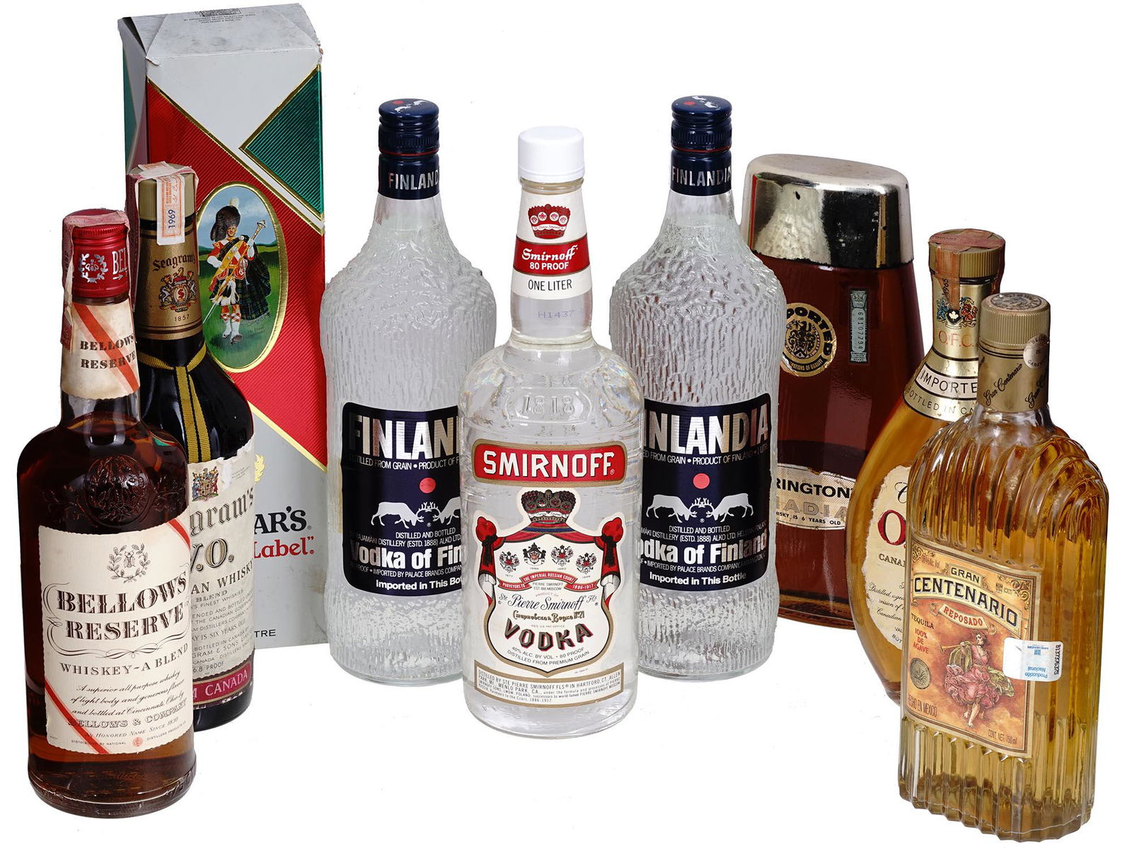 COLLECTION OF VINTAGE LIQUEUR BOTTLES: A collection of nine sealed and open vintage liqueur bottles. The collection includes a White Label Dewars Blended scotch whisky, blended and bottled by John Dewar and Sons Ltd, Scotland; a six yers o