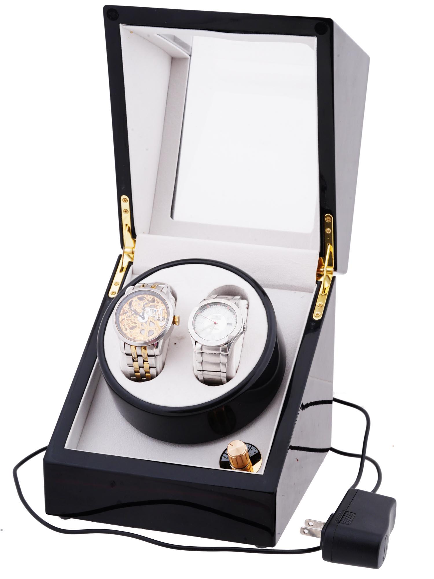 WATCH WINDER WITH TWO INVICTA WRIST WATCHES: The lot includes an automatic wooden watch winder box, designed for two wristwatches. Black lacquered body, lid with transparent matte insert. Contains two wrist watches: an Invicta skeleton dial wris