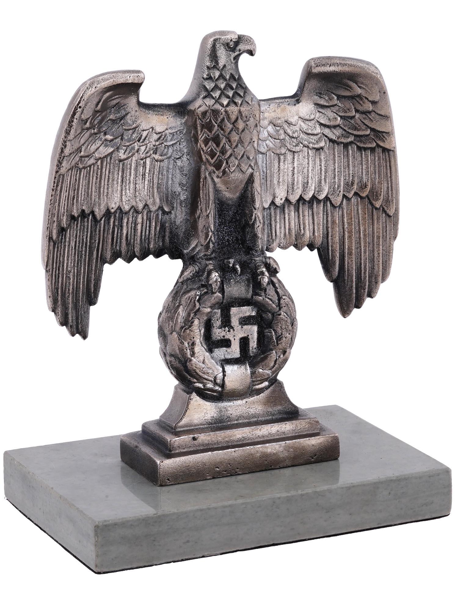 NAZI GERMAN 3RD REICH NUREMBERG DESK EAGLE FIGURE: A WWII Nazi German Third Reich Nuremberg desk eagle figurine. Modeled after the bronze Nuremberg eagles positioned to each side of the main podium at the Nuremberg rally grounds. Mounted to a stone ba