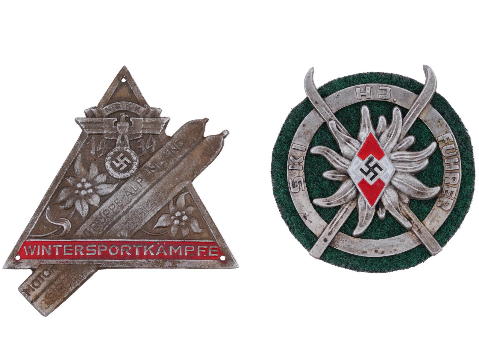 GERMAN WWII MOUNTAIN TROOPS SKI HITKER YOUTH BADGES: A lot of two WWII Nazi German Mountain Troops commemorative plaques The plaques are covered with enamel in red and black shades. The plaques are drilled for attachment to a wall plaque or a car radiat