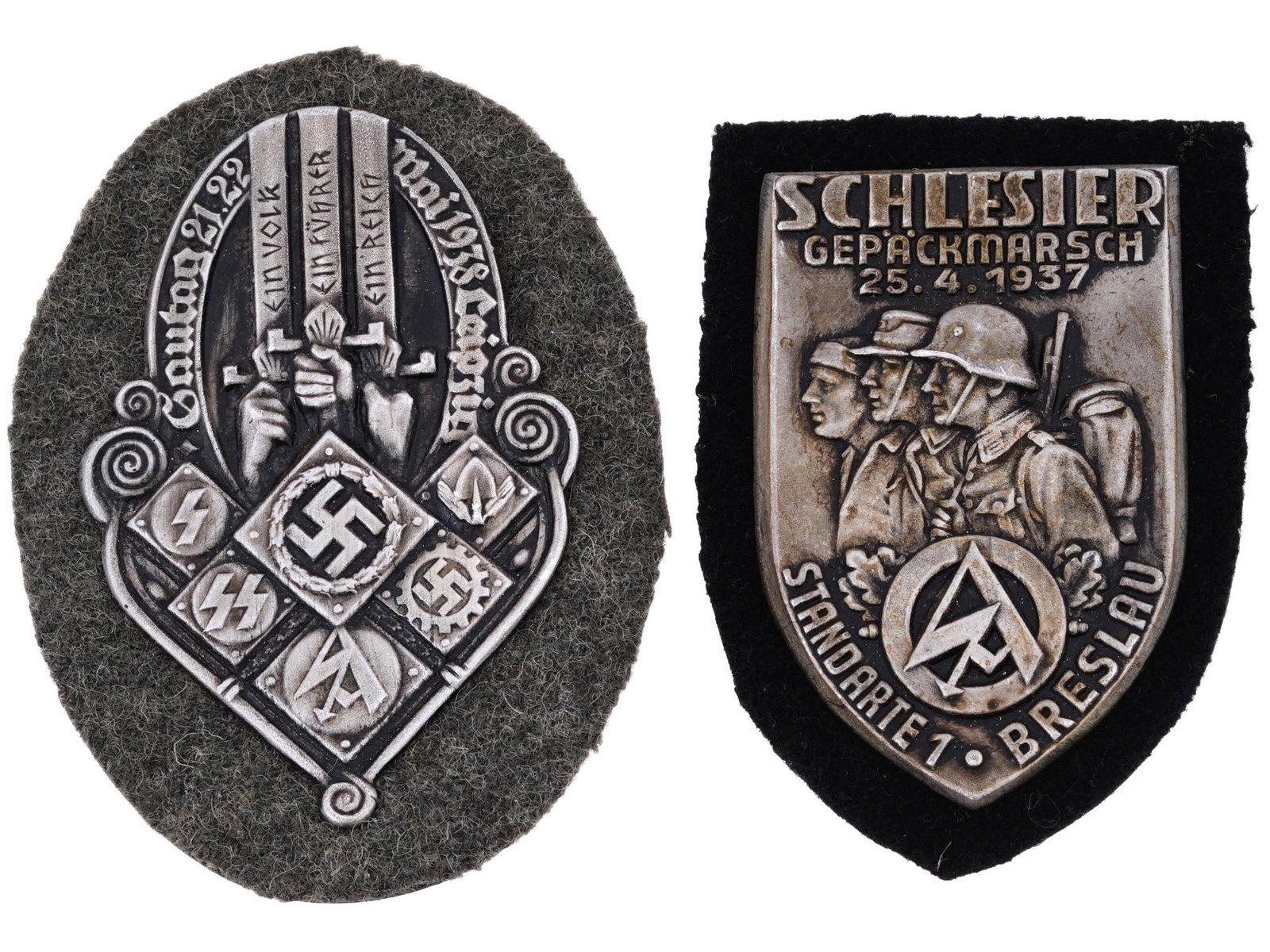 WWII GERMAN NAZI THIRD REICH MILITARY PIN SHIELDS: A pair of WWII German Nazi Third Reich Military metal pin shields. The first is a Gautag Leipzig Organizations badge with engraved swastika insignias. The second is a Silesian baggage march standard B