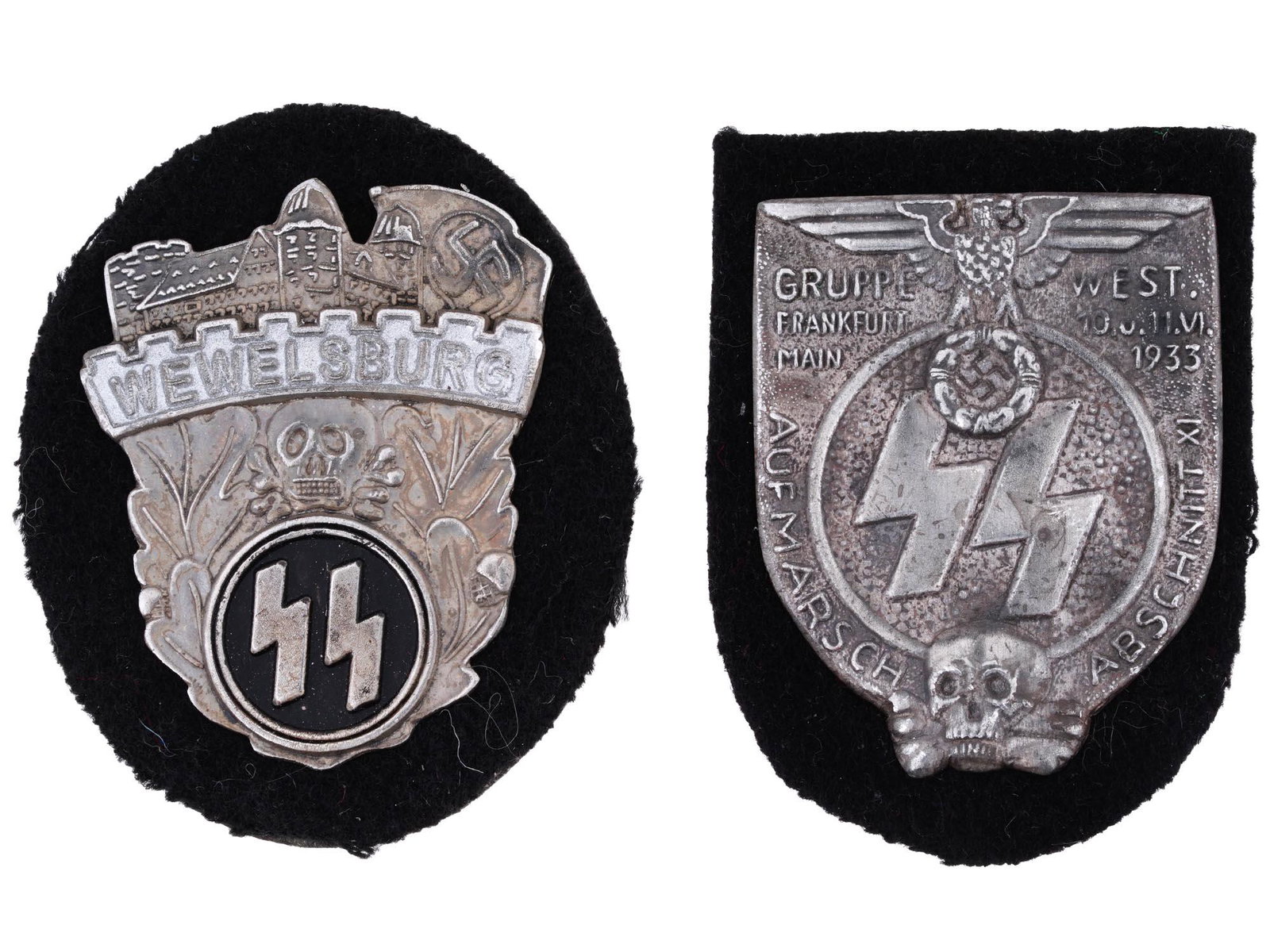 WWII NAZI GERMAN WAFFEN SS WEWELSBURG SHIELDS: A pair of WWII Nazi German Waffen SS shields including a Wewelsburg SS Academy sleeve badge shield with engraved images of a castle and a swastika on top, the inscription Wewelsburg, oak leaves, a sku