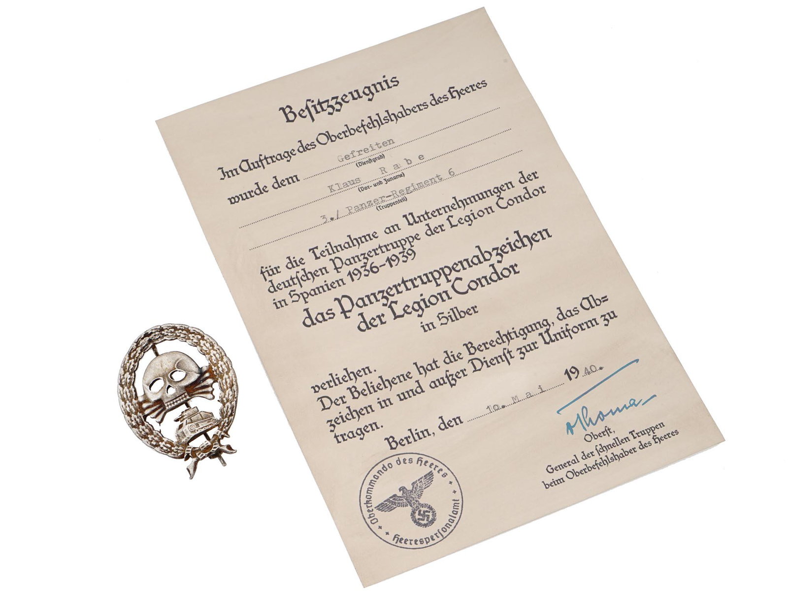 WWII NAZI GERMAN CONDOR LEGION TANK BADGE WITH CERTIFICATE: A WWII Nazi German Condor Legion Tank Badge issued in silver bronze featuring an oval wreath of oak leaves containing a skull and crossbones above a representation of a German Panzer I tank. The skull