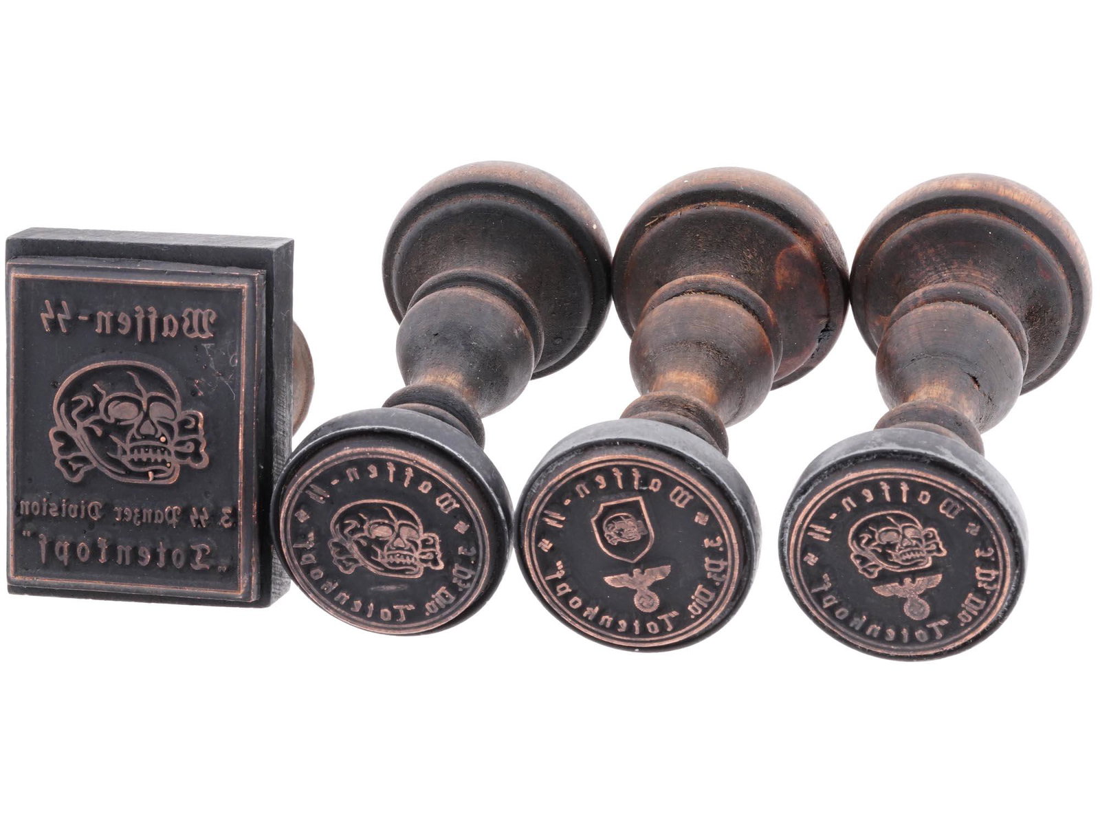 GROUP OF 4 GERMAN WWII HAND STAMPS: A lot of four World War II Nazi German wooden seals of Waffen SS Division Totenkopf. The 3rd SS Panzer Division Totenkopf was an elite division of the Waffen-SS of Nazi Germany during World War II, so