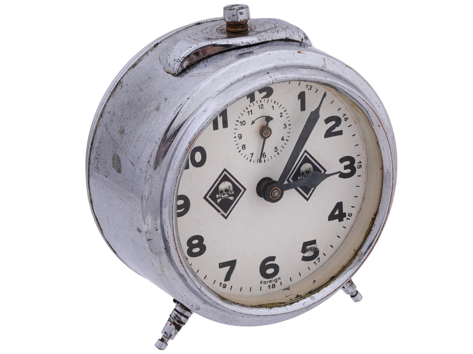 GERMAN WWII WAFFEN SS TOTENKOPF ALARM CLOCK: A WWII Nazi German Waffen SS Totenkopf alarm clock. A white enameled dial with black Arabic numerals and hands, and a pair of Totenkopf skull swastika insignias, to the center. Inscribed, Foreign, low