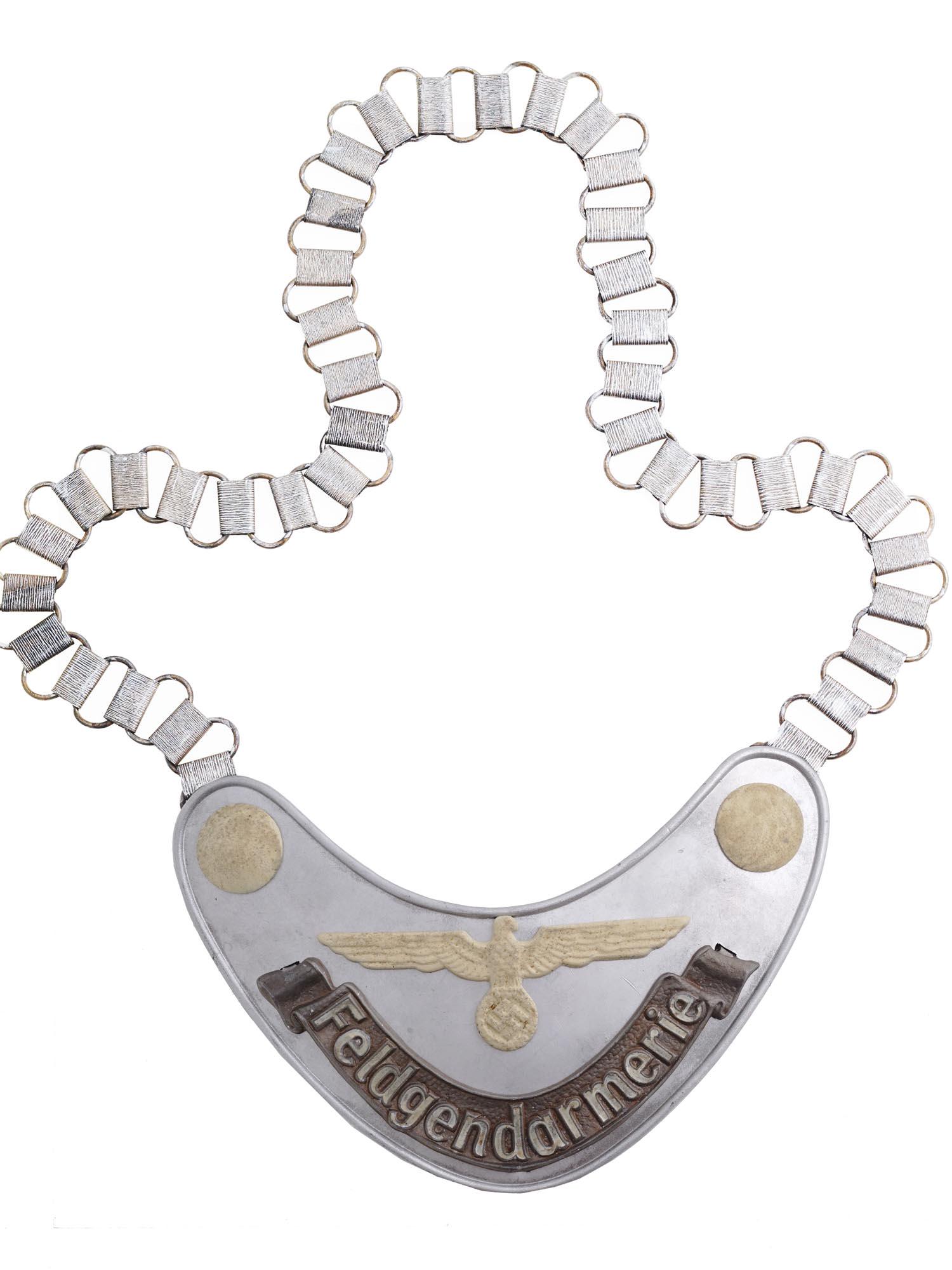 GERMAN WWII LUFTWAFFE FIELD ZHANDARM GORGET WITH CHAIN: A WWII Nazi German Luftwaffe Military Field Police Feldgendarmerie gorget. The gorget is made of die stamped steel construction aluminum coated. The Luftwaffe eagle with a swastika and buttons are pai