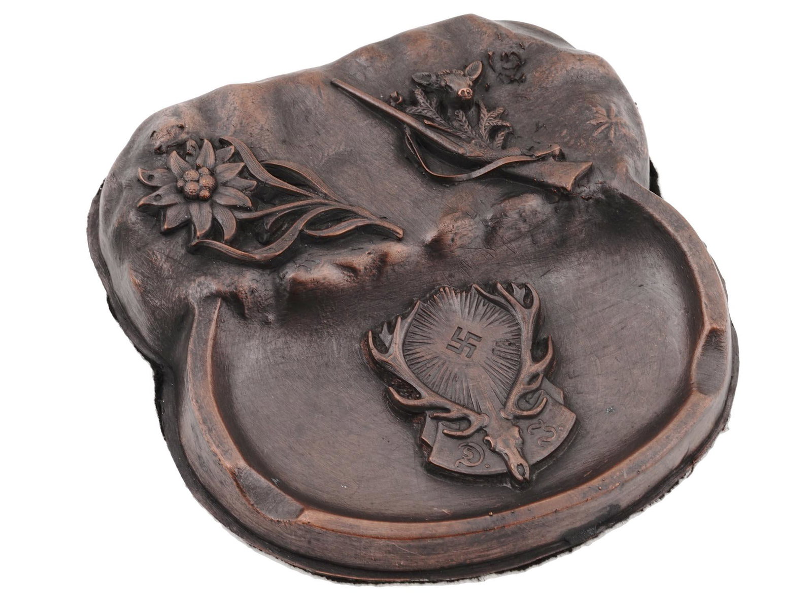 GERMAN WWII THIRD REICH HUNTING SOCIETY ASHTRAY: WWII Nazi German Third Reich Hunting Society guest house ashtray. The ashtray features relief images of an Edelweiss flower, a deer with a gun, and a head of a deer with a swastika insignia. Felt back