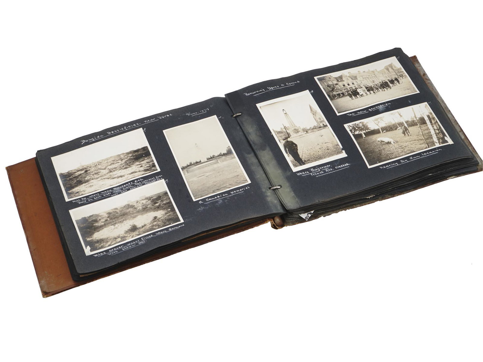 1927 BELGIUM TRAVEL SCRAPBOOK WITH PHOTOGRAPHS: An antique photo album with leather covers and black pages on rings. The album is filled with black and white photographs, bills, tickets and postcards dedicated to a trip to Ostend, Belgium. Dated 19