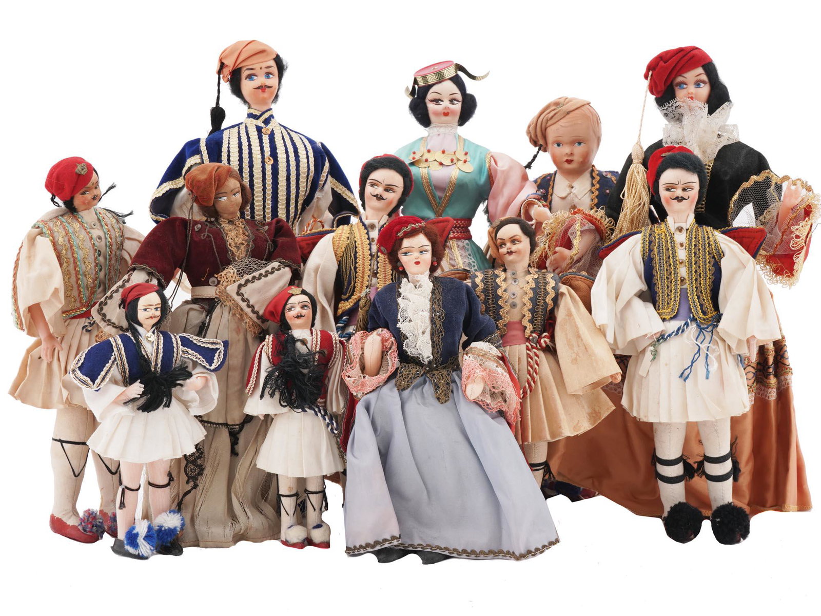 VINTAGE GREEK TRADITIONAL FEMALE AND MALE DOLLS: Twelve vintage Greek traditional female and male dolls. Each doll is meticulously crafted to represent the traditional attire and distinctive characteristics of different regions and customs in Greece
