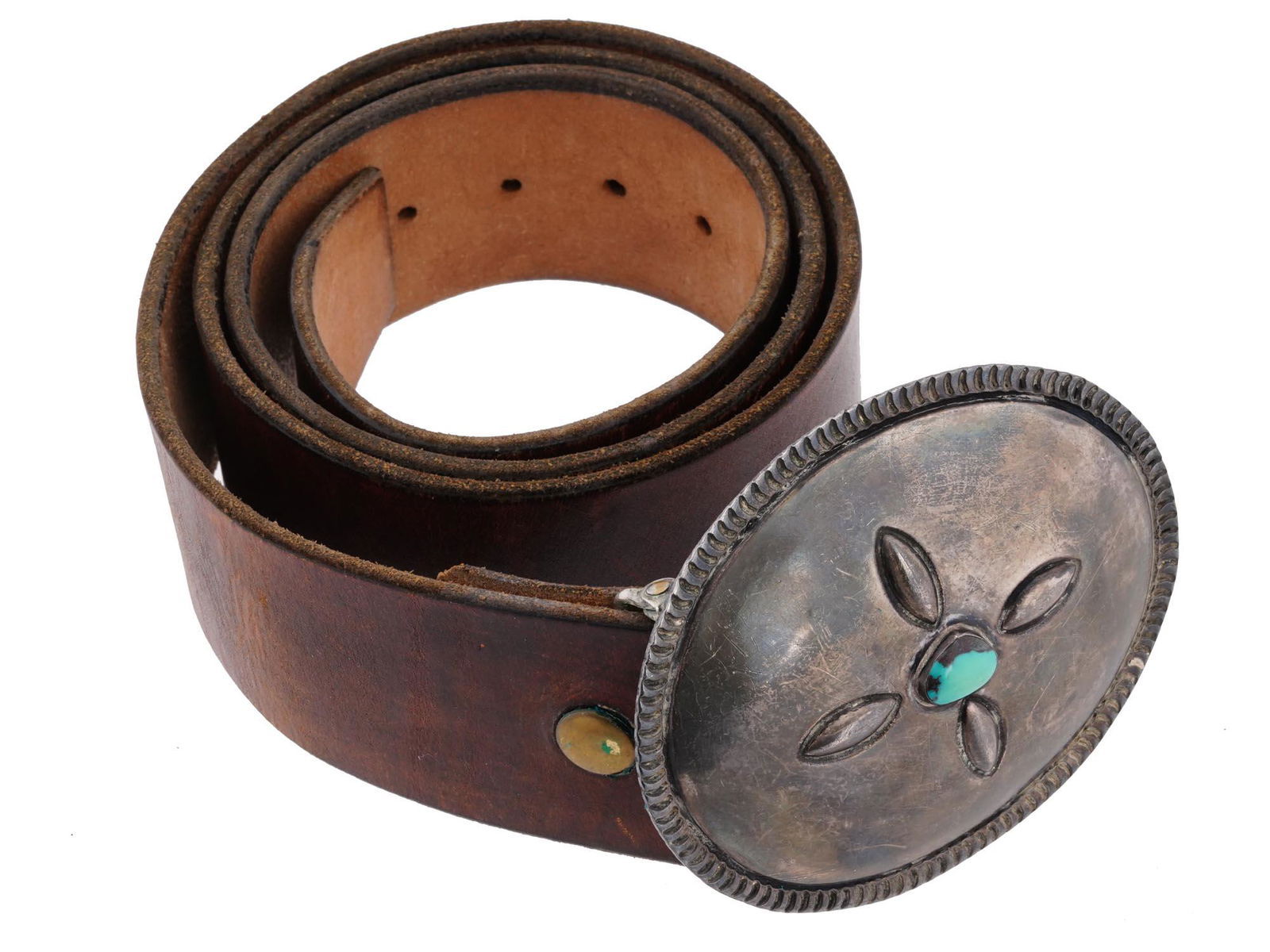 NATIVE AMERICAN LEATHER AND SILVER BUCKLE BELT: A leather belt originating from the Southwest United States. The craftsmanship of the sterling silver buckle reflects the rich traditions and artistry of Native American culture. The vibrant turquoise