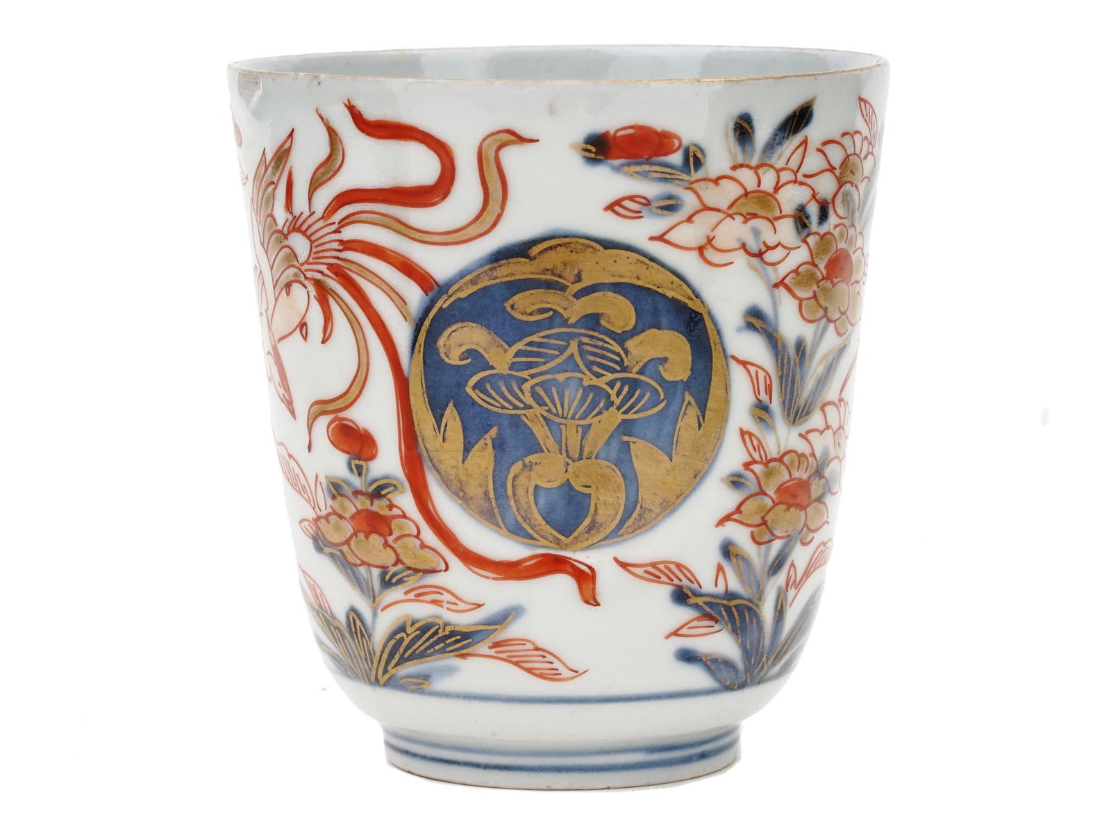 ANTIQUE JAPANESE MEIJI PERIOD IMARI PORCELAIN CUP: An antique Japanese, late Meiji era, hand enameled porcelain cup. The exterior of the cup is hand painted with Imari decor, floral and foliage ornaments in red and blue shades, and an image of a Phoen