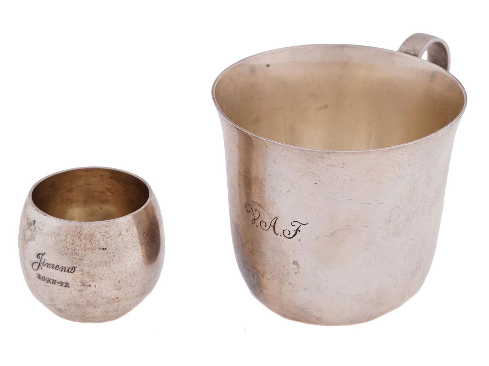 VINTAGE TIFFANY STERLING SILVER TEA CUP AND VODKA CUP: A vintage American tea cup and vodka cup crafted from sterling silver. These cups embody the renowned quality and design aesthetic that Tiffany and Co. is known for. The tea cup features a classic sil