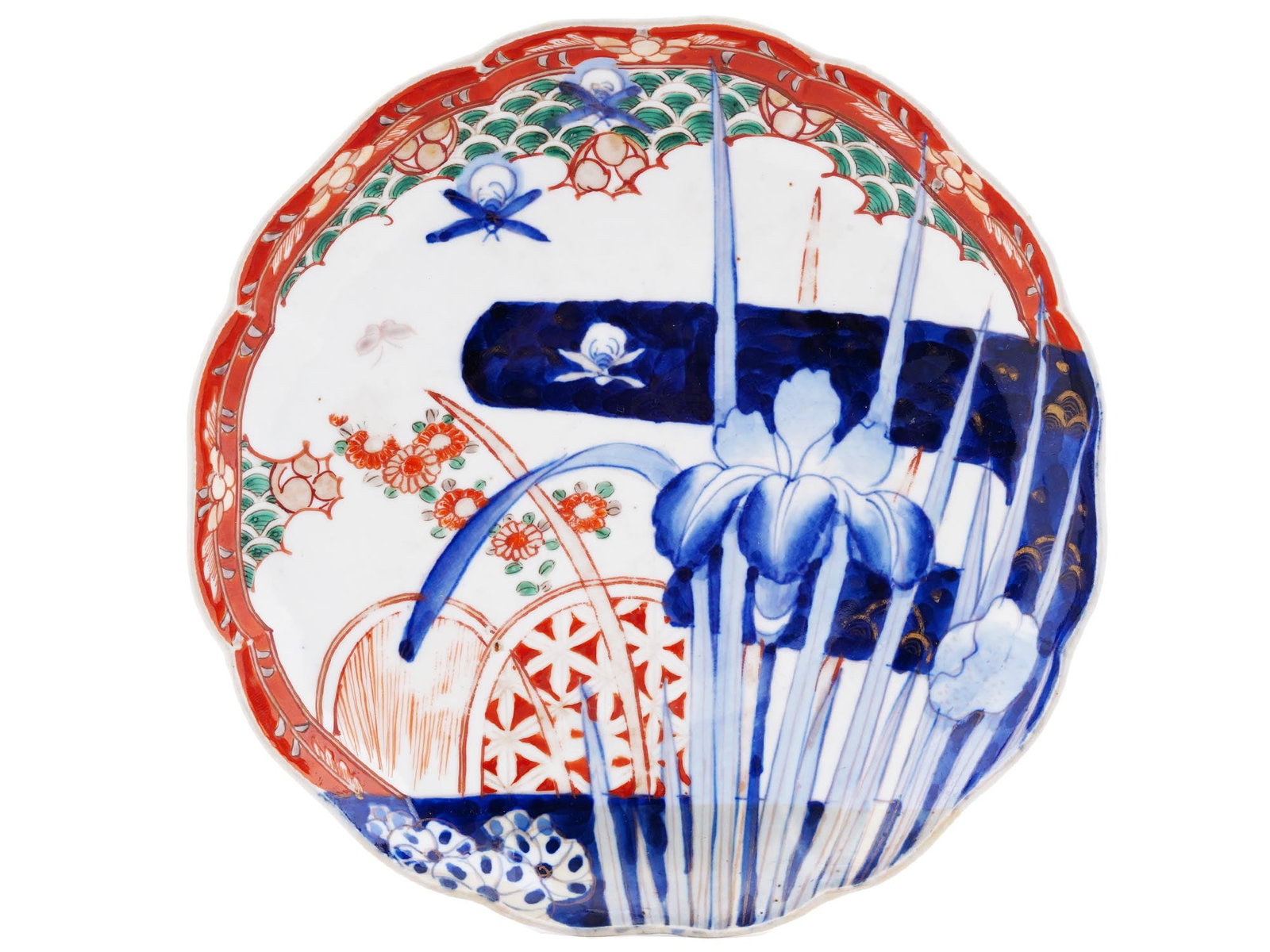 ANTIQUE JAPANESE IMARI PORCELAIN DESSERT PLATE: A Japanese Imari-style porcelain dessert plate. Presumably late Meiji era, before 1912. White plate with hand-painted cobalt blue and red floral decor, iris flowers and dragonflies. The backside is ga