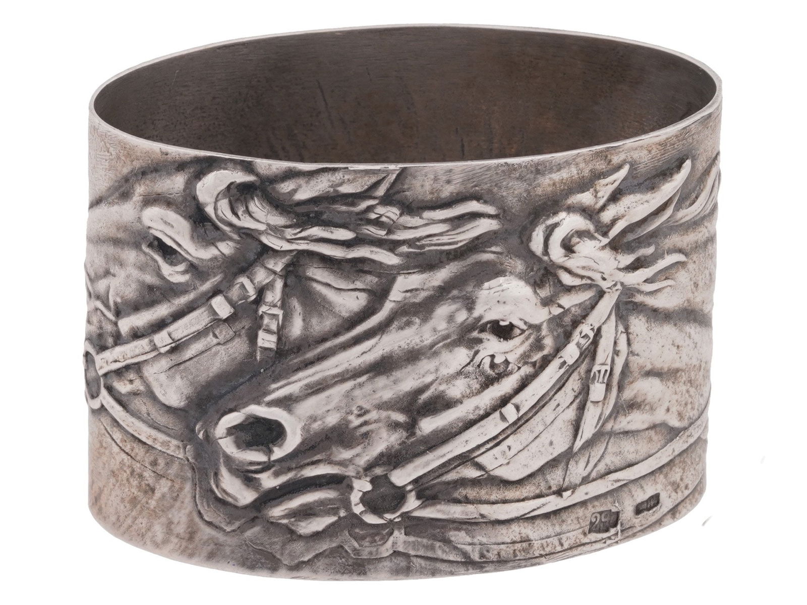 RUSSIAN 84 SILVER NAPKIN RING: A Russian silver napkin ring featuring relief images of horses heads. Hallmarked with 84 Russian silver proof and manufacturer marks. Weight: 39 g. Russian Silver Tableware And Serveware Collectibles.