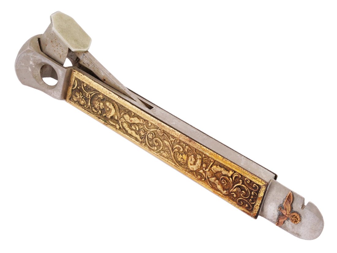 WWII NAZI GERMAN NSDAP MEMBERS CIGAR CUTTER: A WWII Nazi German NSDAP members cigar cutter featuring applied embossed putti decorations, as well as a Parteiadler image of the Nazi Party. Second World War Historical Collectibles And Memorabilia. 