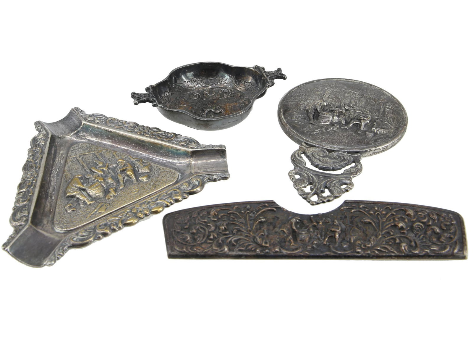 ANTIQUE GERMAN AND DUTCH MENS ACCESSORIES: A set of antique German and Dutch mens accessories including a metal chased case for a hair comb, a metal chased ashtray of a triangle from with a central decorative scene, a chased metal bowl hallmar