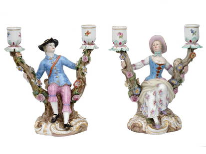 ANTIQUE 19TH C GERMAN MEISSEN PORCELAIN CANDELABRA: A pair of antique German Meissen porcelain two-light candelabra with figural gentleman and lady seated between trees, and wearing 18th century costume. The twin branched candelabra encrusted all over