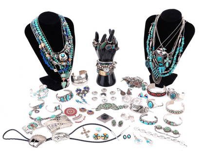 LOT OF NATIVE AMERICAN SILVER TURQUOISE JEWELRY: A lot of Native American jewelry mostly made of silver and set with natural semi precious stones like turquoise, carnelian, lapis lazuli, jasper, and other stones. The lot includes bangle bracelets, w